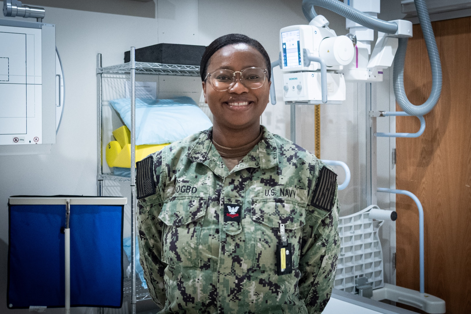 Hospital Corpsman 2nd Class Emmanuella Gbogbo serves as a radiology technologist and the leading petty officer of Navy Medicine Readiness and Training Command Cherry Point’s radiology department.  
A native of Ghana, West Africa, Gbogbo leads a team whose work provides rapid, accurate imaging to assist in the diagnosis and treatment of service members’ injuries to return them to full duty status as quickly as possible.