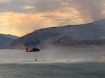 A Utah National Guard UH-60 Black Hawk collects water in a bucket from East Canyon Reservoir while aerial firefighting operations in support of the Rocky Canyon Fire in Morgan County, Utah, Aug. 9, 2026. Utah National Guard aviation crews are supporting local and government agencies as wildfires continue to impact communities across the state. Photo by Chief Warrant Officer 4 Chris Aylstock.