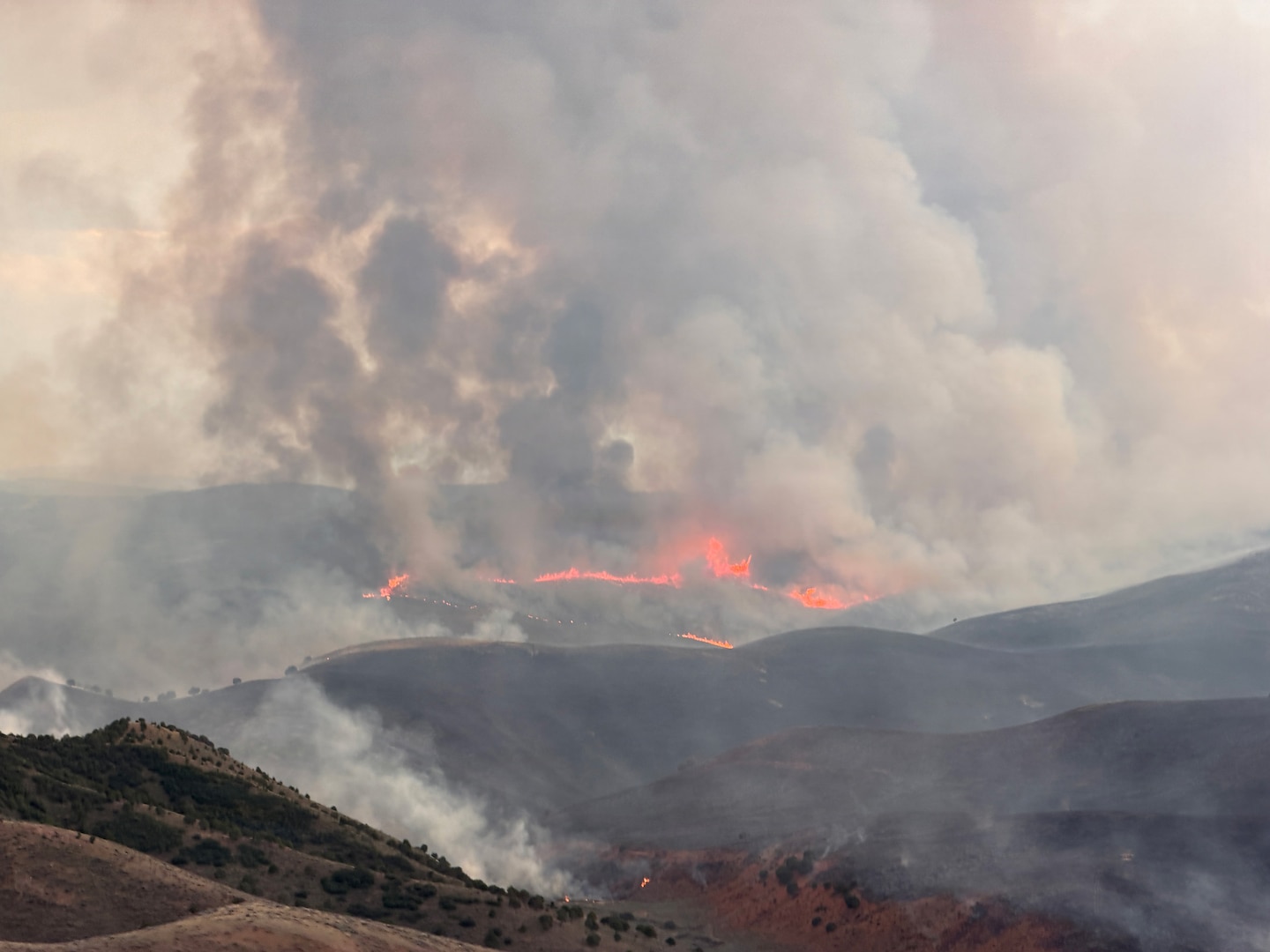An aerial view from a Utah National Guard UH-60 Black Hawk as it conducts aerial firefighting operations in support of the Rocky Canyon Fire in Morgan County, Utah, Aug. 11, 2026.