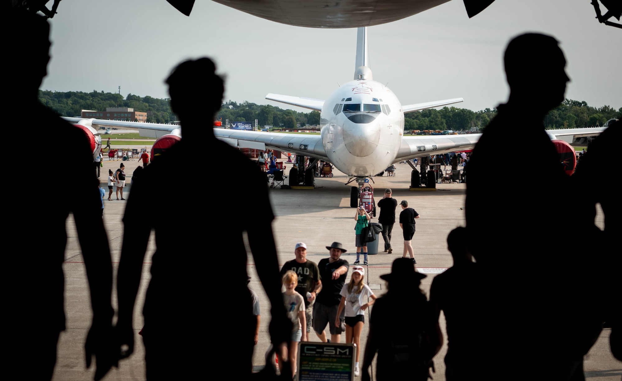 Local community members walk through the cargo area of a C-5M Super Galaxy as an E-6 static display sits in the background during the 2026 Defenders of Freedom Air & Space Show at Offutt Air Force Base, Nebraska, Aug. 8, 2026. In alignment with the nationwide 'Freedom 250' celebration, the air show highlighted two and a half centuries of American progress, liberty, and the technological leaps made throughout military
aviation history. (U.S. Air Force photo by Daniel Martinez)