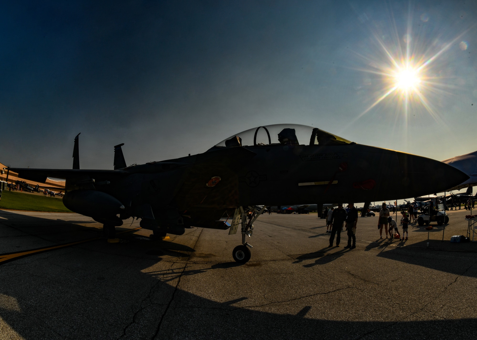 An F-15E Strike Eagle is parked on the flightline as visitors enjoy the sight during the 2026 Defenders of Freedom Air & Space Show at Offutt Air Force Base, Nebraska, Aug. 9, 2026. The open house provided a rare opportunity for loca Greater Omaha residents to interact directly with service members, ask questions, and explore the military aircraft that make the nation's global defense possible. (U.S. Air Force photo by Chad Watkins)