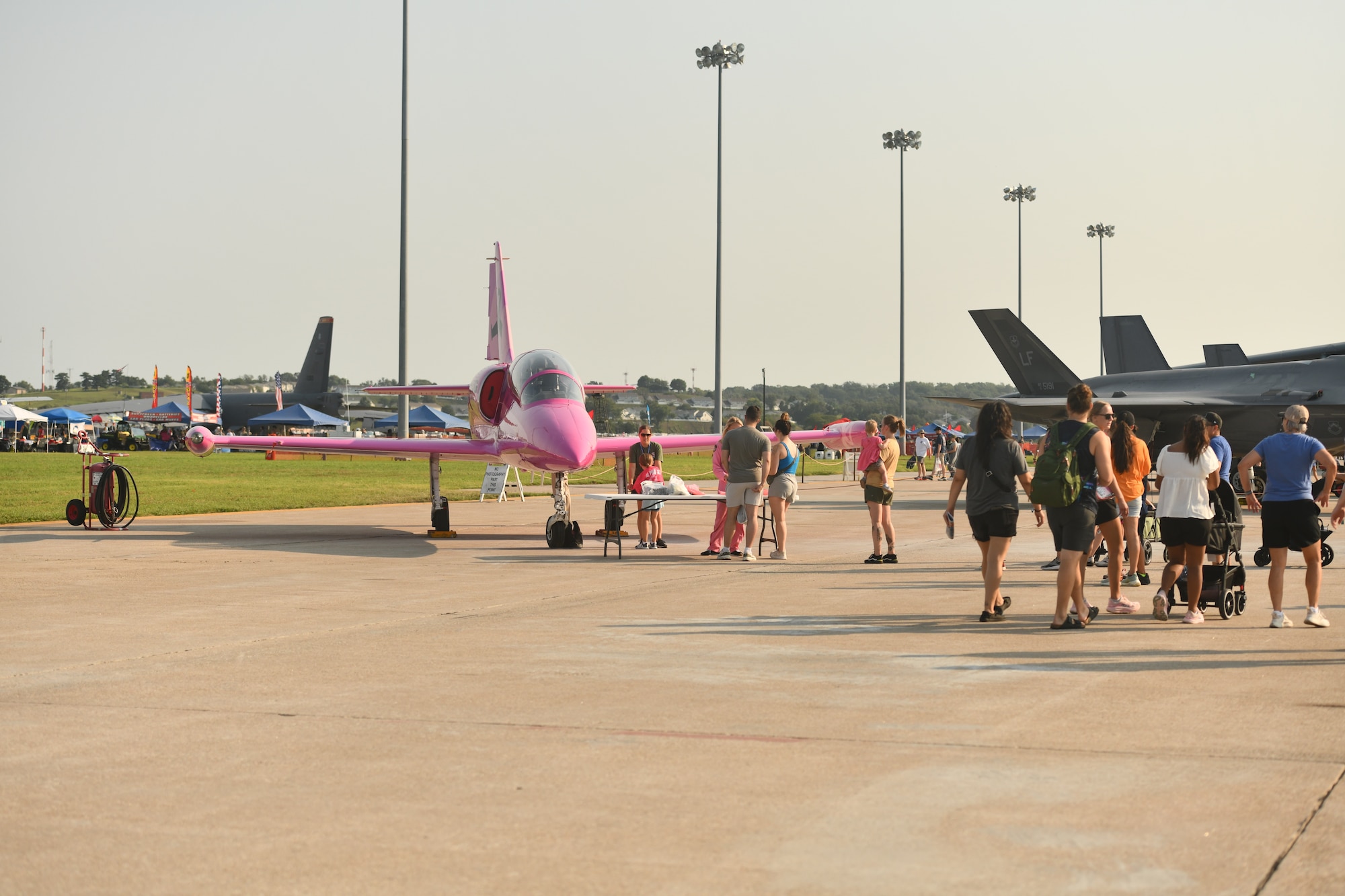 Airshow attendees gather to see the Pink Jet during the 2026 Defenders of Freedom Air & Space show at Offutt Air Force Base, Nebraska, Aug. 9, 2026. The Pink Jet is a special static display dedicated to raising awareness for breast cancer and honoring those affected by the disease. (U.S. Air Force photo by Chad Watkins)