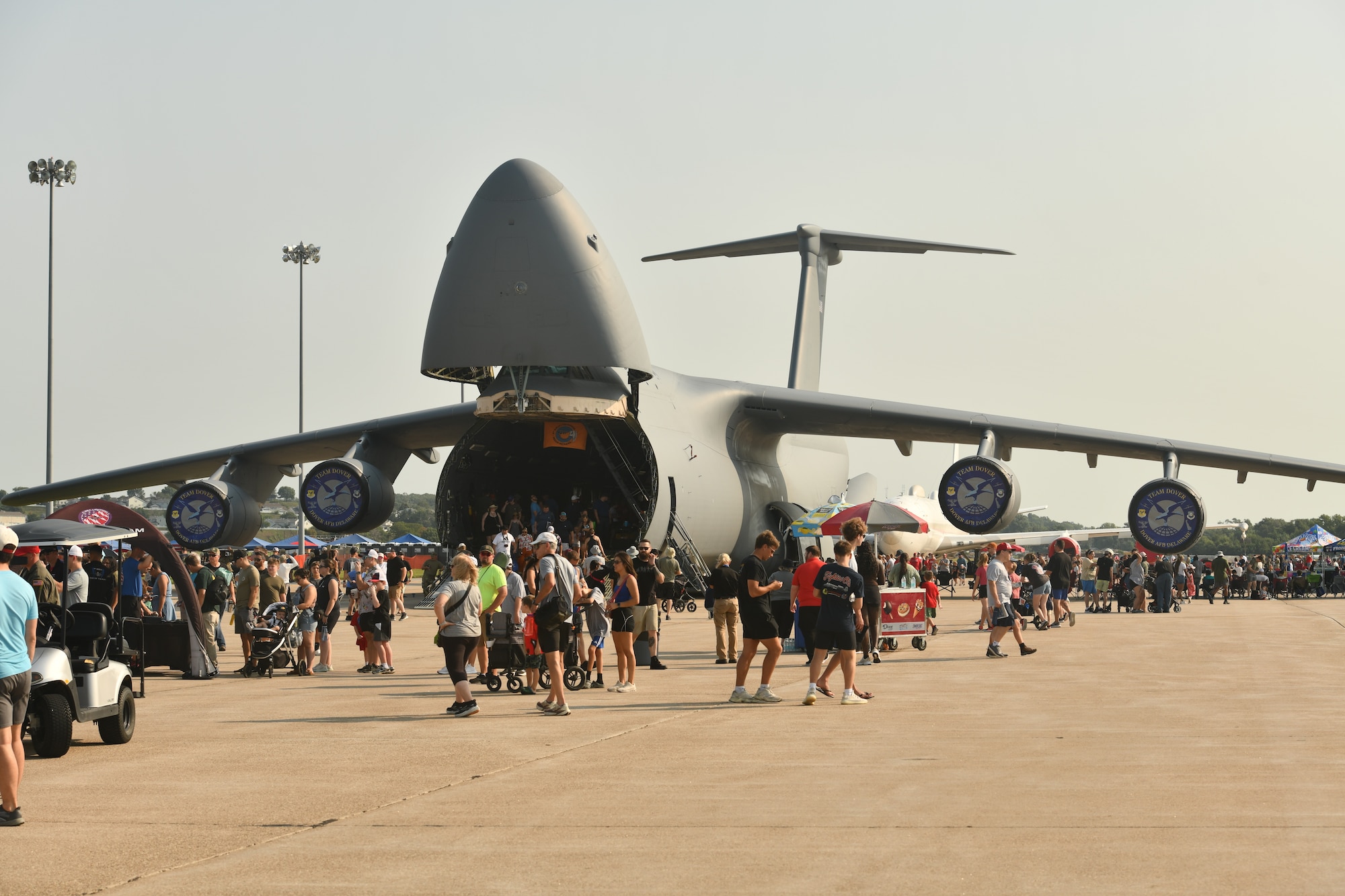 A crowd of people walk by a C-5M Super Galaxy during the 2026 Defenders of Freedom Air & Space Show at Offutt Air Force Base, Nebraska, Aug. 9, 2026. Defenders of Freedom Air & Space Show 2026 served as a free, public open house to foster strong community relations and express appreciation to the local Greater Omaha community. (U.S. Air Force photo by Chad Watkins)