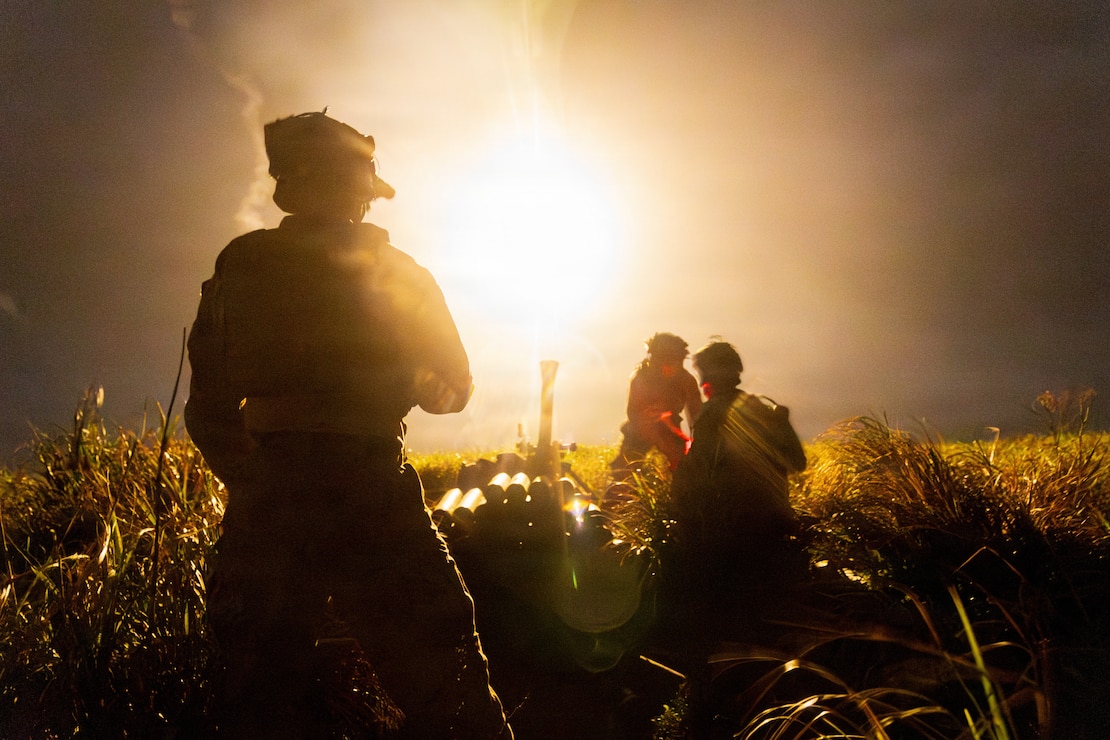 U.S. Marines with 12th Marine Littoral Combat Team, 12th Marine Littoral Regiment, 3rd Marine Division conduct a fire mission during a Tactical Air Control party exercise at W-174 Joint Okinawa Training Range Complex, Irisuna Island, Okinawa, Japan, July 22, 2026. The Marines fired an 81mm luminescent mortar round to provide illumination during night operations while conducting a TACP exercise to increase proficiency and combat readiness. (U.S. Marine Corps photo by Cpl. Logan Smith)
