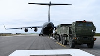A U.S. Army M142 High Mobility Artillery Rocket System, assigned to 17th Long Range Fires and Effects Brigade, waits on the flightline before being loaded into a Royal Canadian Air Force C-17 Globemaster III aircraft in Nome, Alaska, Aug. 11, 2026. The HIMARS was deployed to the Arctic from Joint Base Lewis-McChord in support of Operation TUNDRA MERLIN, showcasing U.S. and Canadian forces' ability to rapidly move combat equipment and personnel across the Arctic. (U.S. Air Force photo by Senior Airman Gabriel Held)