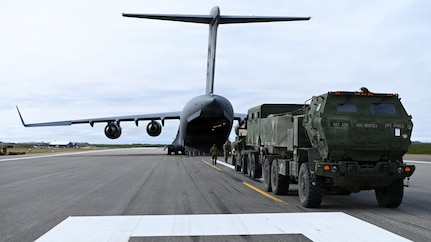 A U.S. Army M142 High Mobility Artillery Rocket System, assigned to 17th Long Range Fires and Effects Brigade, waits on the flightline before being loaded into a Royal Canadian Air Force C-17 Globemaster III aircraft in Nome, Alaska, Aug. 11, 2026. The HIMARS was deployed to the Arctic from Joint Base Lewis-McChord in support of Operation TUNDRA MERLIN, showcasing U.S. and Canadian forces' ability to rapidly move combat equipment and personnel across the Arctic. (U.S. Air Force photo by Senior Airman Gabriel Held)