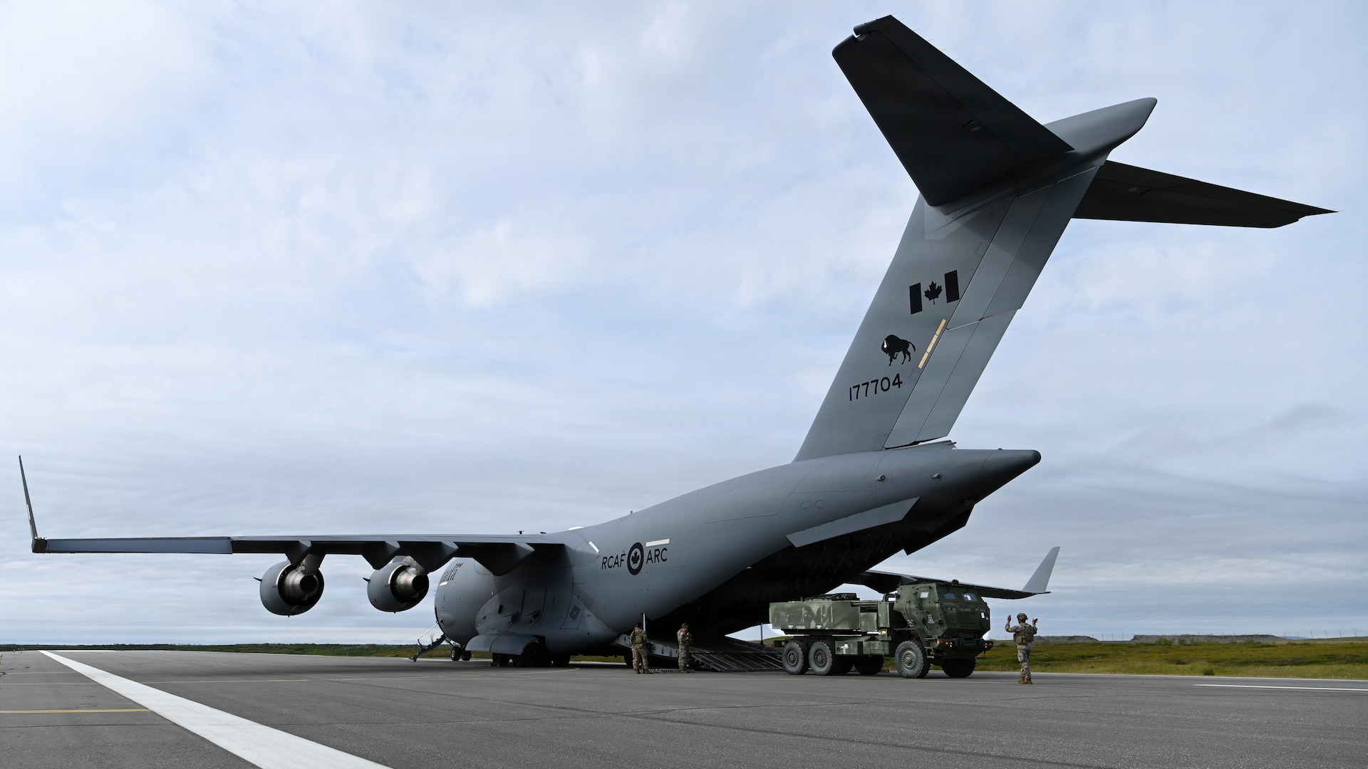 A U.S. Army M142 High Mobility Artillery Rocket System, assigned to 17th Long Range Fires and Effects Brigade, gets loaded into a Royal Canadian Air Force C-17 Globemaster III aircraft in Nome, Alaska, Aug. 11, 2026. The HIMARS was deployed to the Arctic from Joint Base Lewis-McChord in support of Operation TUNDRA MERLIN, showcasing U.S. and Canadian forces' ability to rapidly move combat equipment and personnel across the Arctic. (U.S. Air Force photo by Senior Airman Gabriel Held)