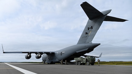 A U.S. Army M142 High Mobility Artillery Rocket System, assigned to 17th Long Range Fires and Effects Brigade, gets loaded into a Royal Canadian Air Force C-17 Globemaster III aircraft in Nome, Alaska, Aug. 11, 2026. The HIMARS was deployed to the Arctic from Joint Base Lewis-McChord in support of Operation TUNDRA MERLIN, showcasing U.S. and Canadian forces' ability to rapidly move combat equipment and personnel across the Arctic. (U.S. Air Force photo by Senior Airman Gabriel Held)