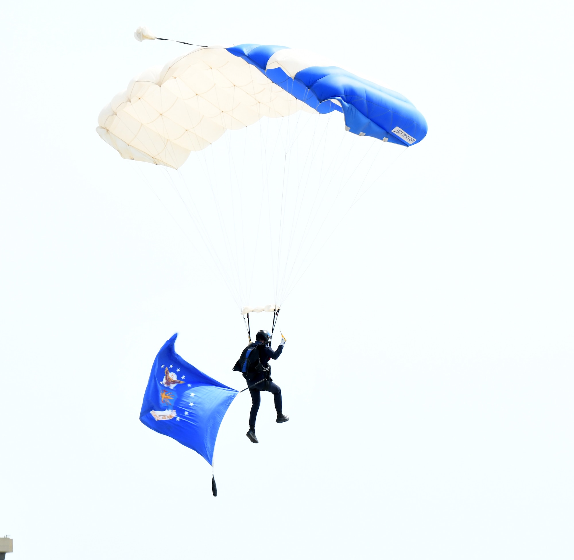A U.S. Air Force Academy Wings of Blue parachuting team member prepares to land with a United States Air Force flag during the Defenders of Freedom Air & Space Show 2026 at Offutt Air Force Base, Nebraska, Aug. 8, 2026. In alignment with the nationwide 'Freedom 250' celebration, the air show highlighted two-and-a-half centuries of American progress, liberty, and the technological leaps made throughout military aviation history. (U.S. Air Force photo by Charles J. Haymond)