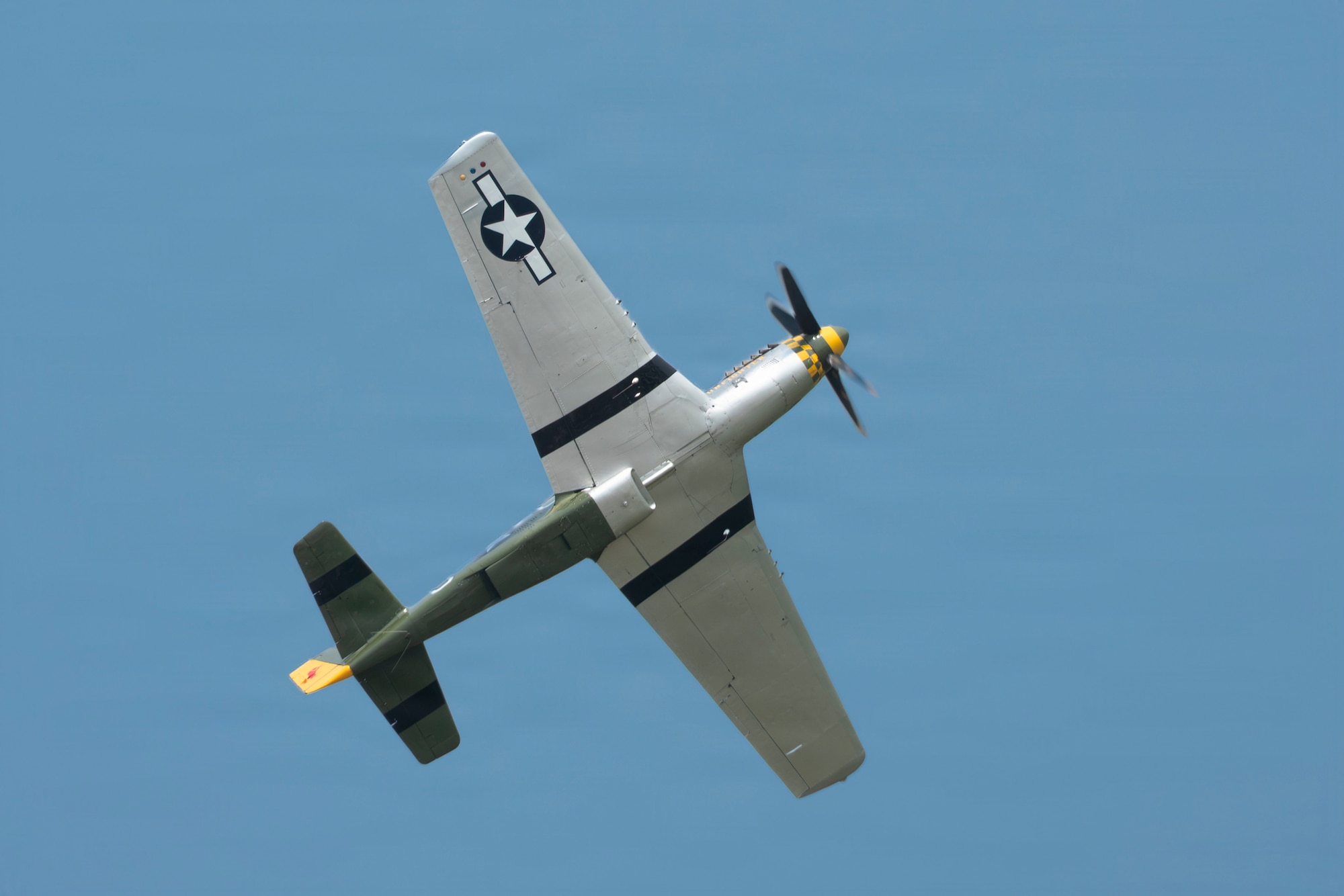 A P-51 Mustang performs aerial maneuvers during the 2026 Defenders of Freedom Air & Space Show at Offutt Air Force Base, Nebraska, Aug. 8, 2026. The event highlighted the historic evolution of military aviation, bridging the gap between legacy heritage platforms and modern combat capabilities to preserve and share military history. (U.S. Air Force photo by Senior Airman Matthew Arachikavitz)