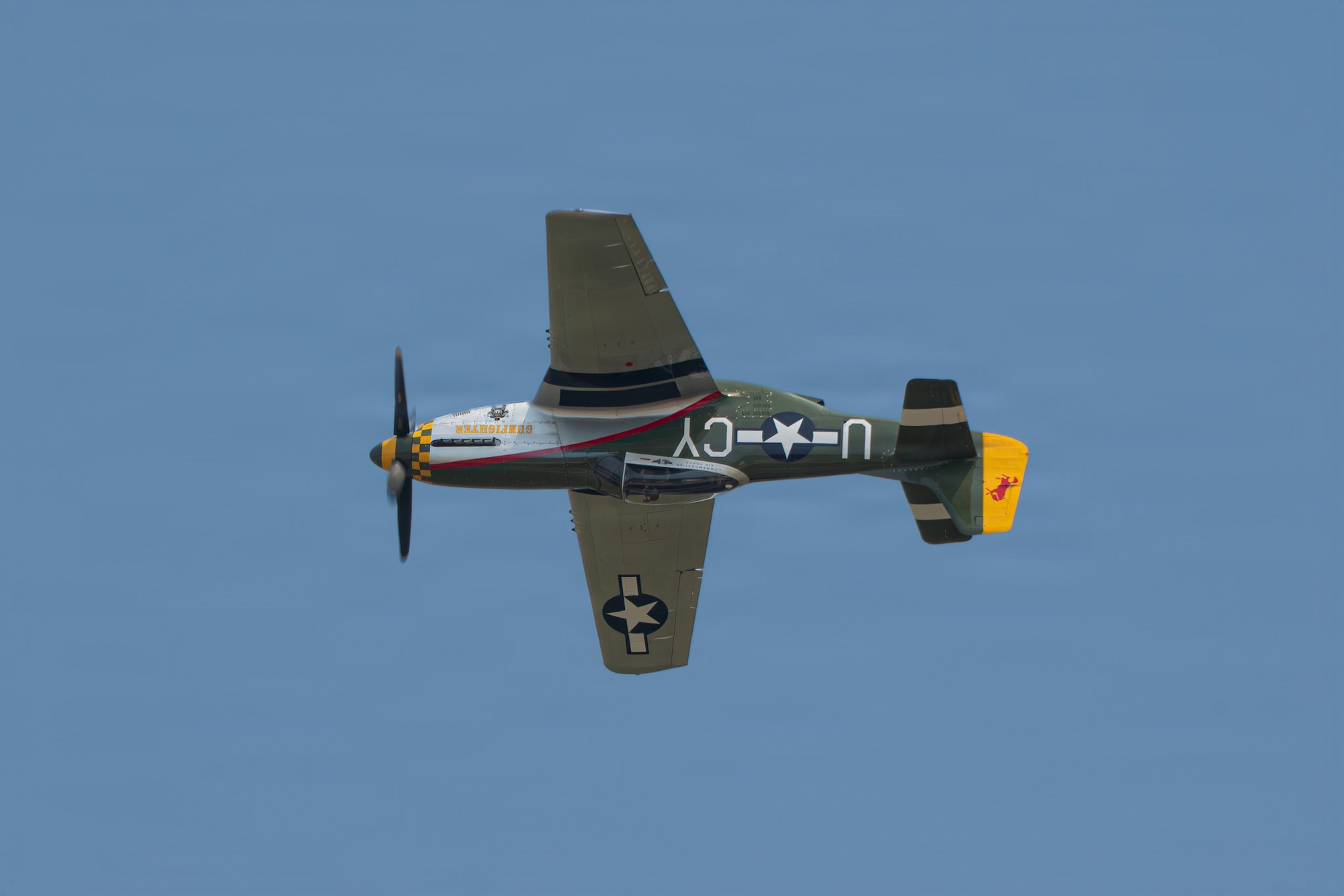 A P-51 Mustang performs an inverted aerial maneuver during the 2026 Defenders of Freedom Air & Space Show at Offutt Air Force Base, Nebraska, Aug. 8, 2026. The event highlighted the historic evolution of military aviation, bridging the gap between legacy heritage platforms and modern combat capabilities to preserve and share military history. (U.S. Air Force photo by Senior Airman Matthew Arachikavitz)