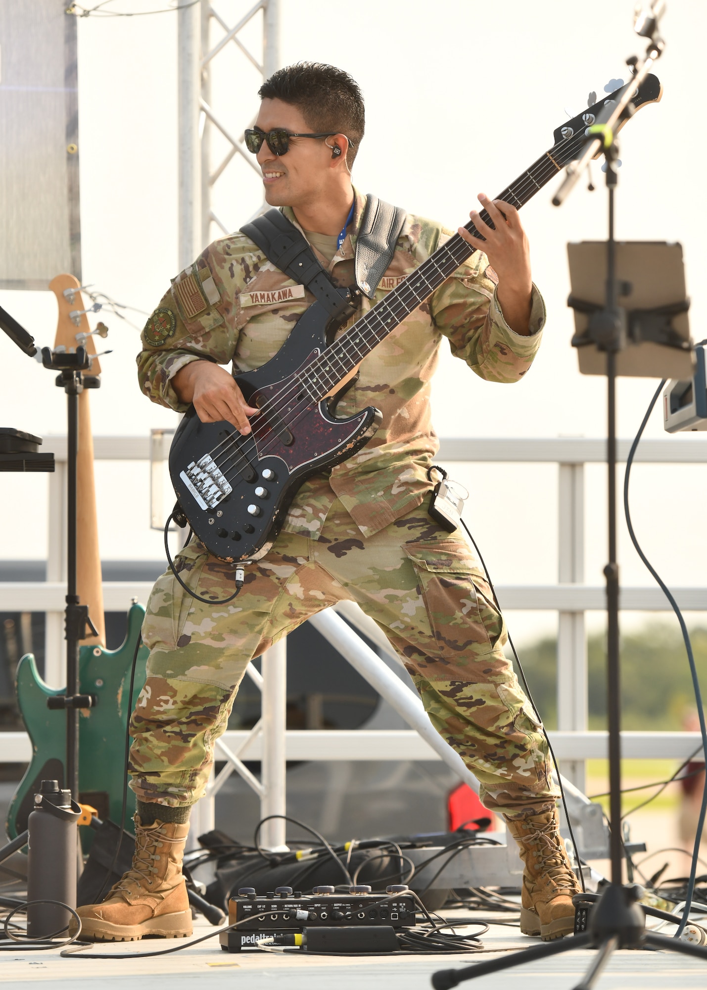 Senior Airman Jin Yamakawa, United States Air Force Heartland of America Band bassist, rocks out during the Defenders of Freedom Air & Space Show 2026 at Offutt Air Force Base, Nebraska, Aug. 8, 2026. The air show served as a free, public open house to foster community relations and express appreciation to the local Greater-Omaha community. (U.S. Air Force photo by Chad Watkins)