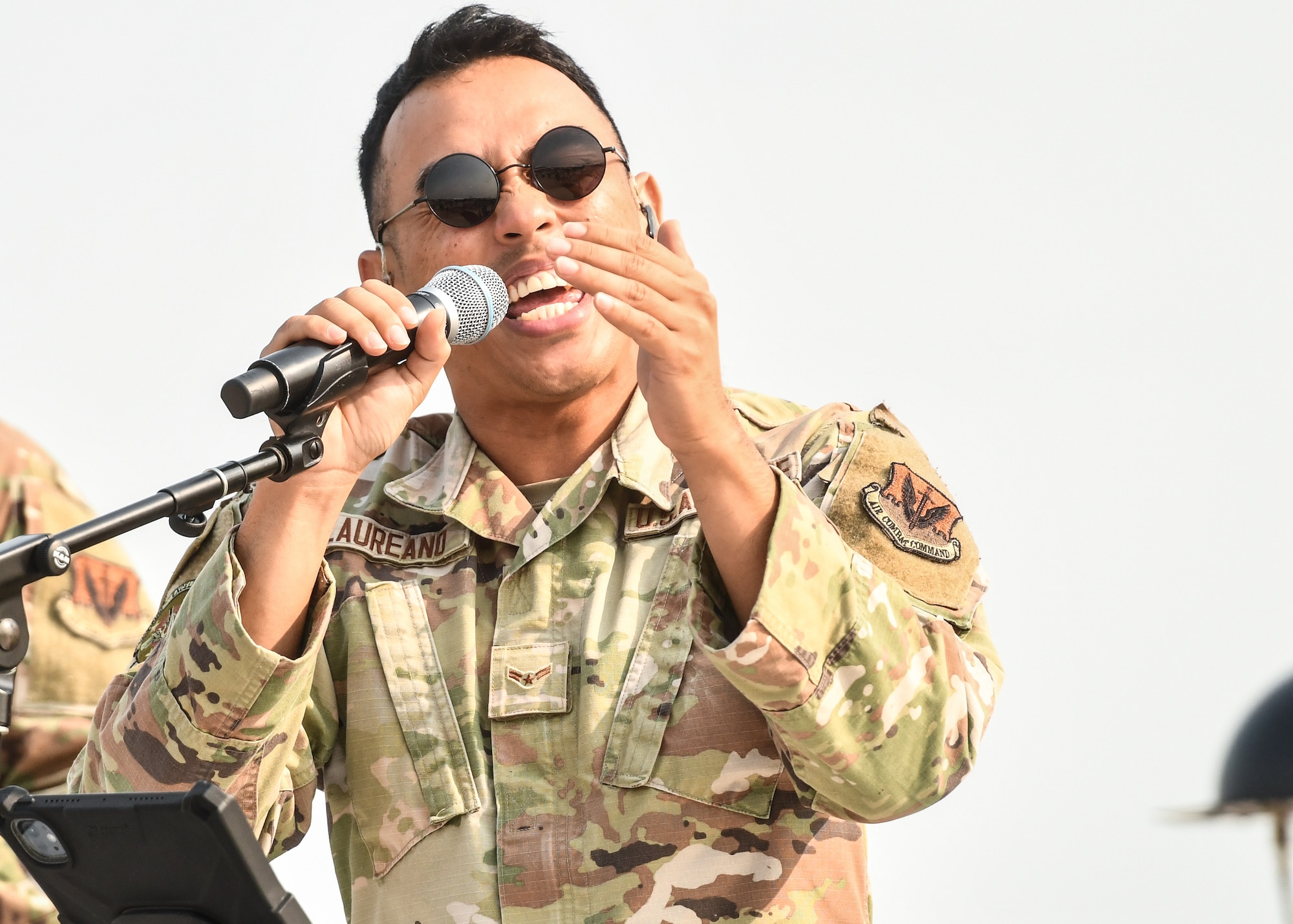 Airman 1st Class Lawrence Laureano, United States Air Force Heartland of America Band vocalist, performs during the Defenders of Freedom Air & Space Show 2026 at Offutt Air Force Base, Nebraska, Aug. 8, 2026. The air show served as a free, public open house to foster strong community relations and express appreciation to the local Greater-Omaha community. (U.S. Air Force photo by Chad Watkins)