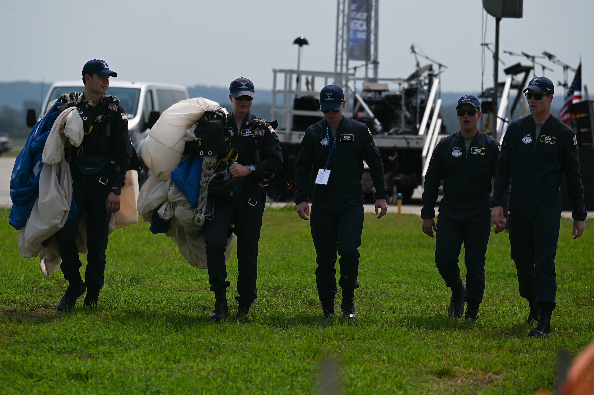 U.S. Air Force Academy Wings of Blue parachuting team walks back to equipment during the 2026 Defenders of Freedom Air & Space Show at Offutt Air Force Base, Nebraska, Aug. 9, 2026. Defenders of Freedom Air & Space Show 2026 served as a free, public open house to foster strong community relations and express appreciation to the local Greater Omaha community. (U.S. Air Force Photo by Airman 1st Class Charles Bolden)