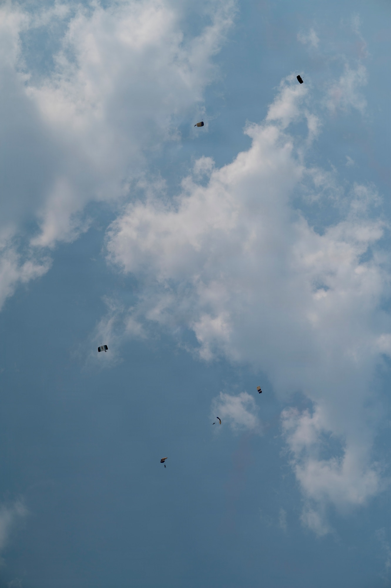 U.S. Air Force Academy Wings of Blue parachuting team performs canopy maneuvers during the 2026 Defenders of Freedom Air & Space Show at Offutt Air Force Base, Nebraska, Aug. 9, 2026. The biennial air show served as a key community outreach event, aiming to inspire the next generation of aviators by highlighting the diverse career paths and unwavering dedication of today's Airmen. (U.S. Air Force photo by Senior Airman Matthew Arachikavitz)