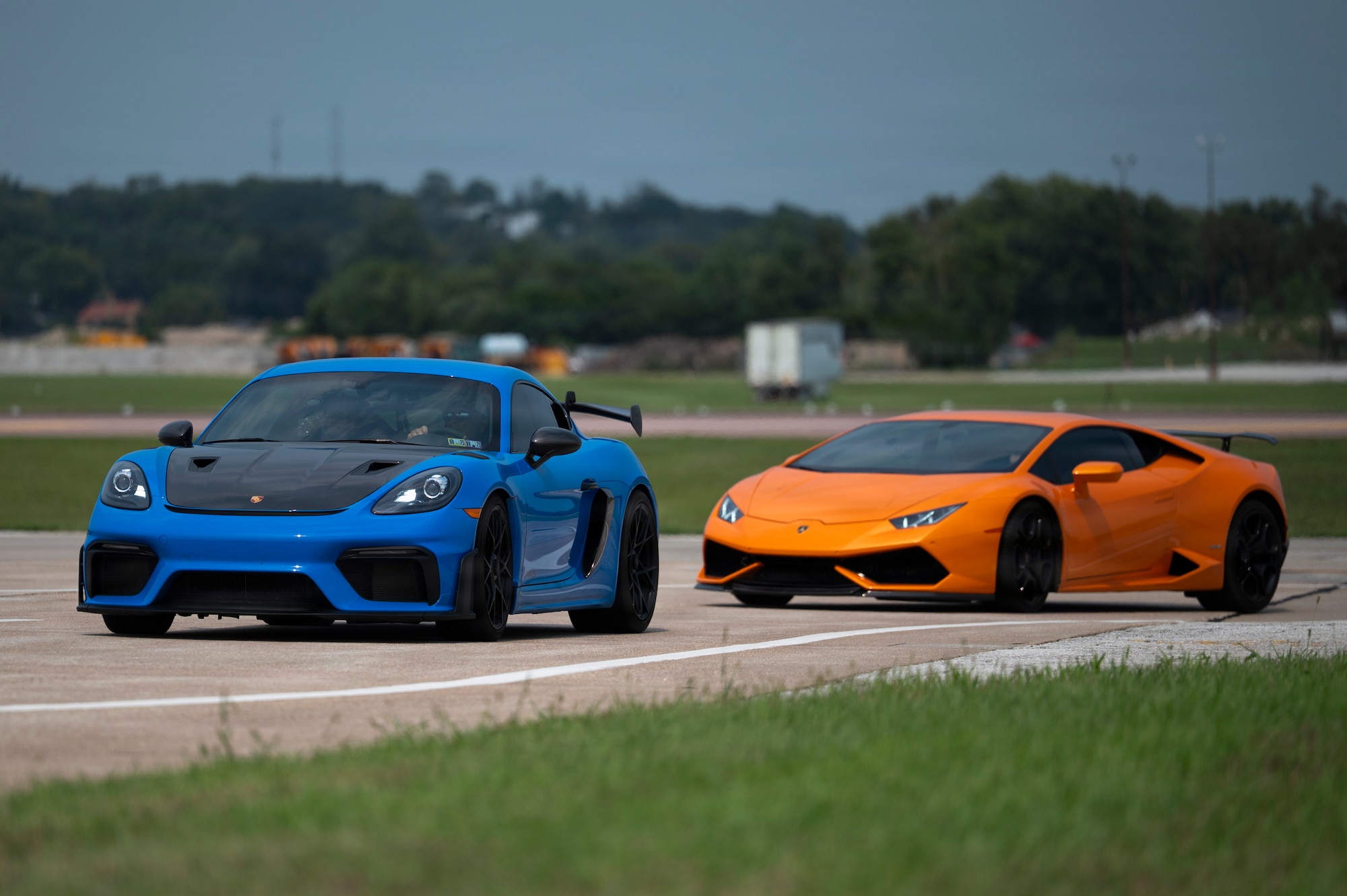 Precision Exotics drive a Porsche 911 GT3 and Lamborghini Huracan Evo on the flightline during the 2026 Defenders of Freedom Air & Space Show at Offutt Air Force Base, Nebraska, Aug. 9, 2026. DoF 2026 served as a free, public open house to foster strong community relations and express appreciation to the local Greater Omaha community. (U.S. Air Force photo by Senior Airman Matthew Arachikavitz)