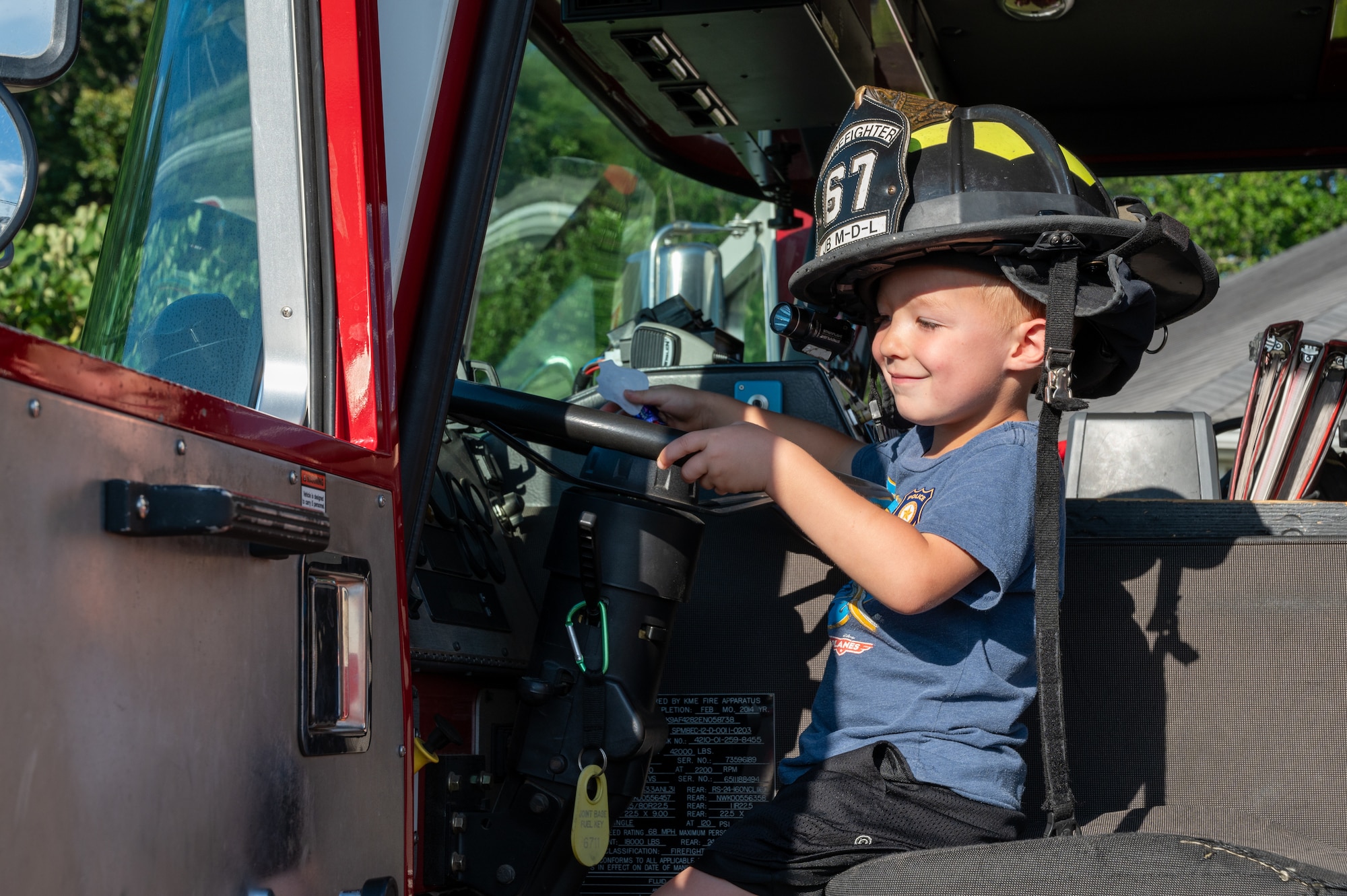A child fist-bumps Eddie “The Ready Dragon”, 87th Civil Engineer Squadron Emergency Management mascot, during National Night Out at Joint Base McGuire-Dix-Lakehurst, N.J., Aug. 4, 2026.