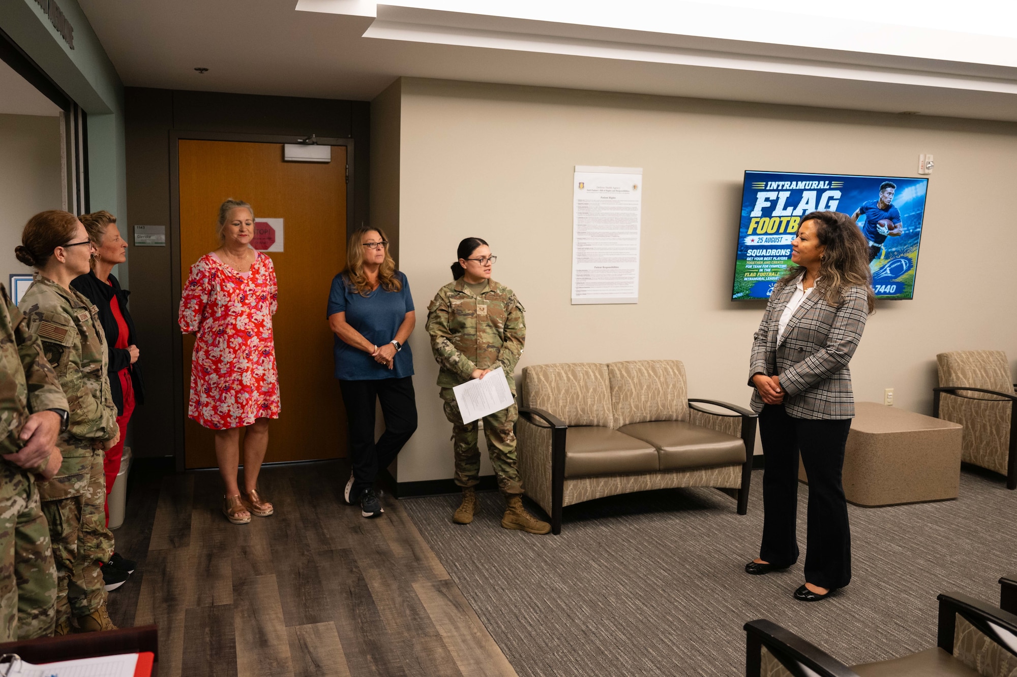 Mei-Ling C. Taylor, deputy director and chief of staff for Defense Health Network Central, left, coins Tiffany Gibbs, Altus clinic resource management office resource advisor, at Altus Air Force Base, Oklahoma, July 30, 2026. As the resource advisor, Gibbs manages unit finances, tracks budgets, and acts as a financial liaison. (U.S. Air Force photo by Senior Airman Jonah Bliss)