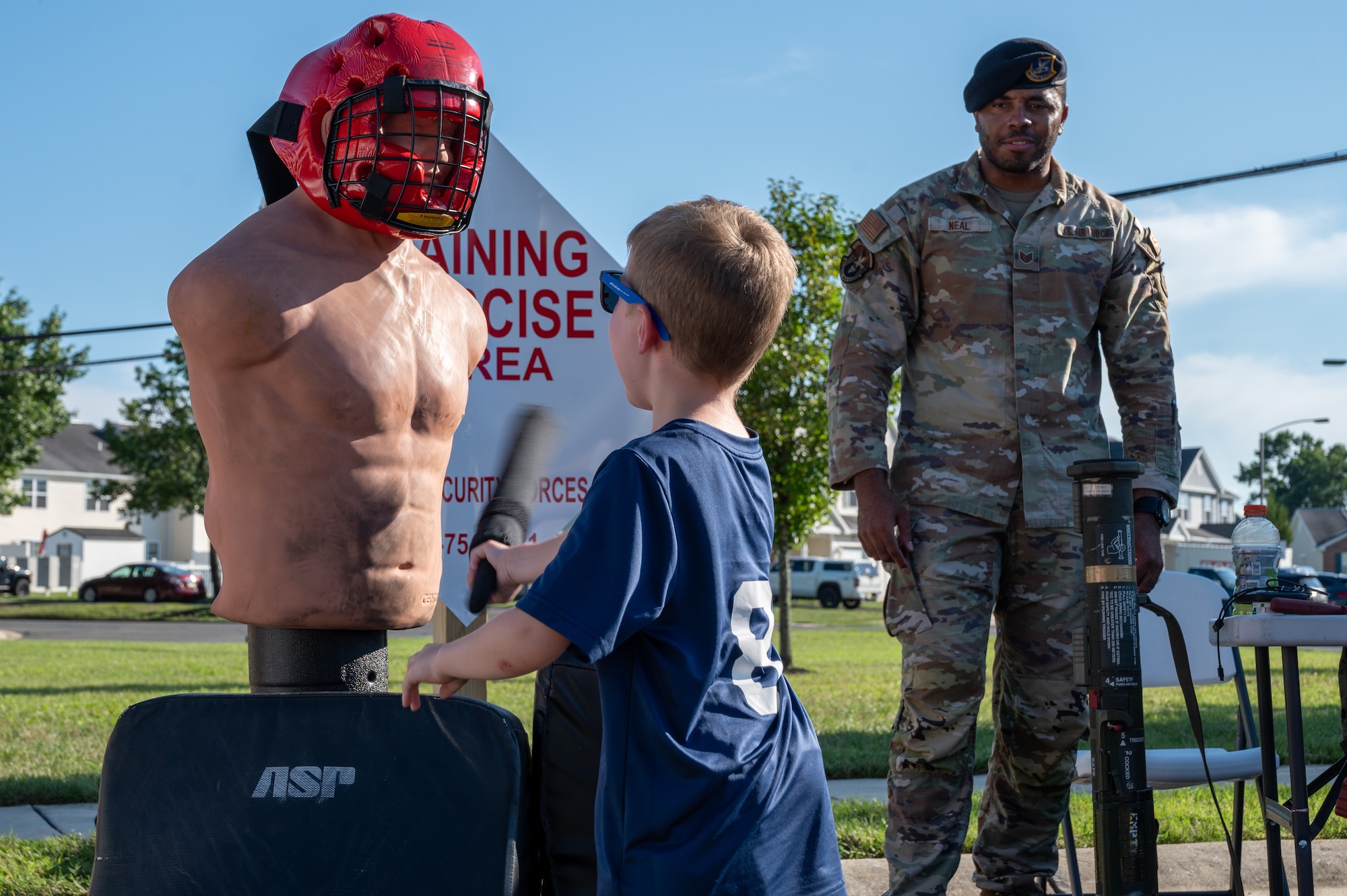 Wayne Russell, 87th Civil Engineer Squadron Emergency Management deputy, talks with a child at the 87th CES Emergency Management table during National Night Out at Joint Base McGuire-Dix-Lakehurst, N.J., Aug. 4, 2026.