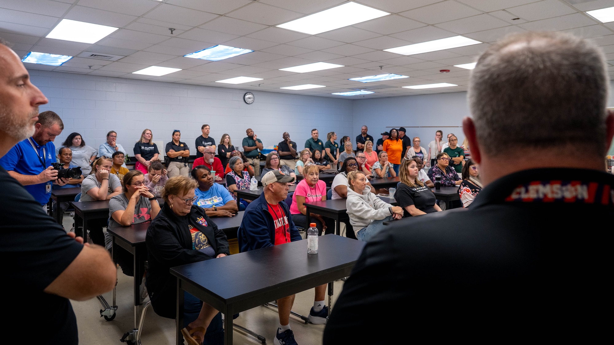 A photo of a classroom of people receiving a lecture.