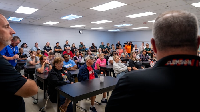 A photo of a classroom of people receiving a lecture.
