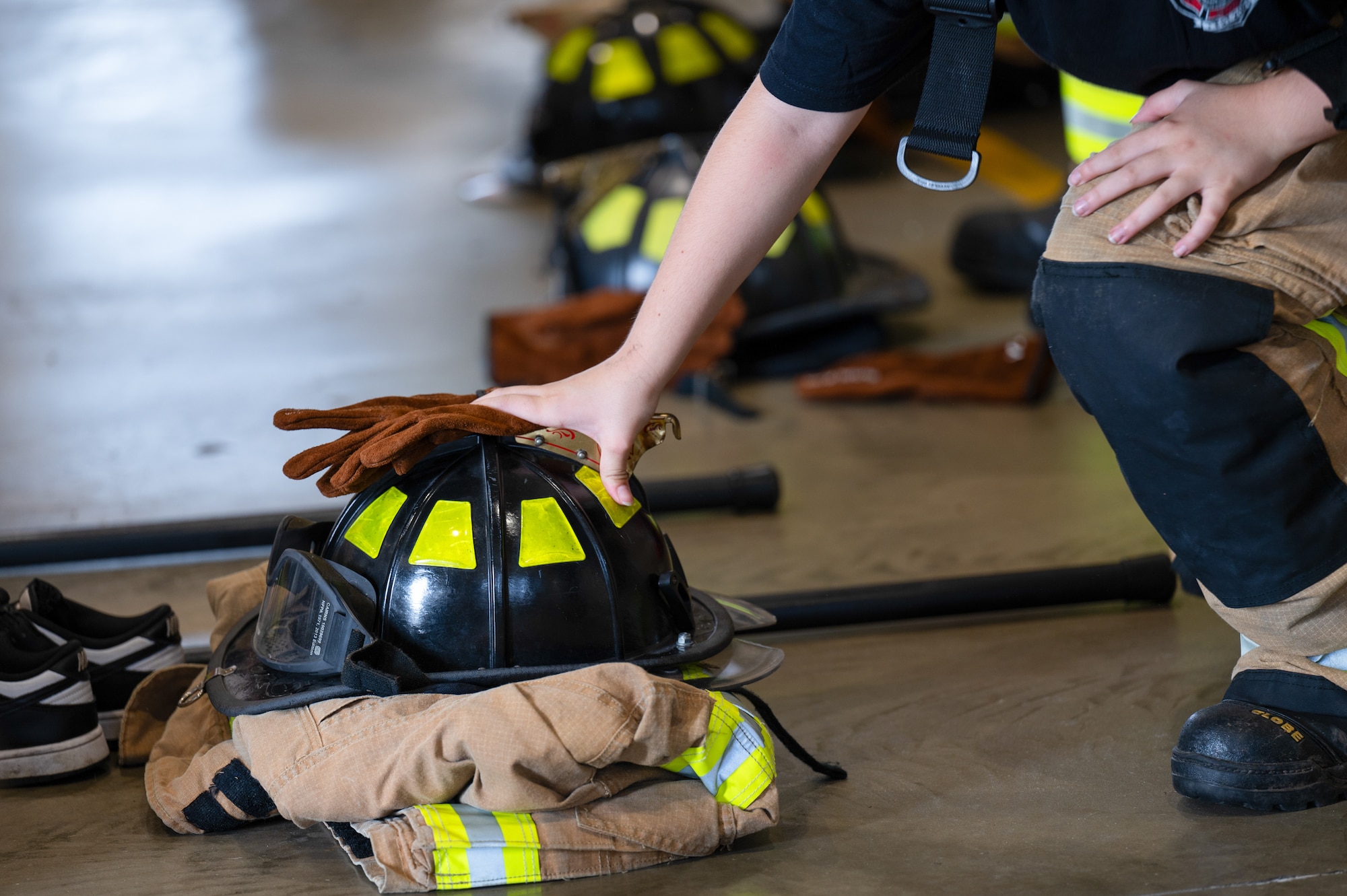 A junior fire academy recruit places their gear down at Joint Base McGuire-Dix-Lakehurst, N.J., July 27, 2026.