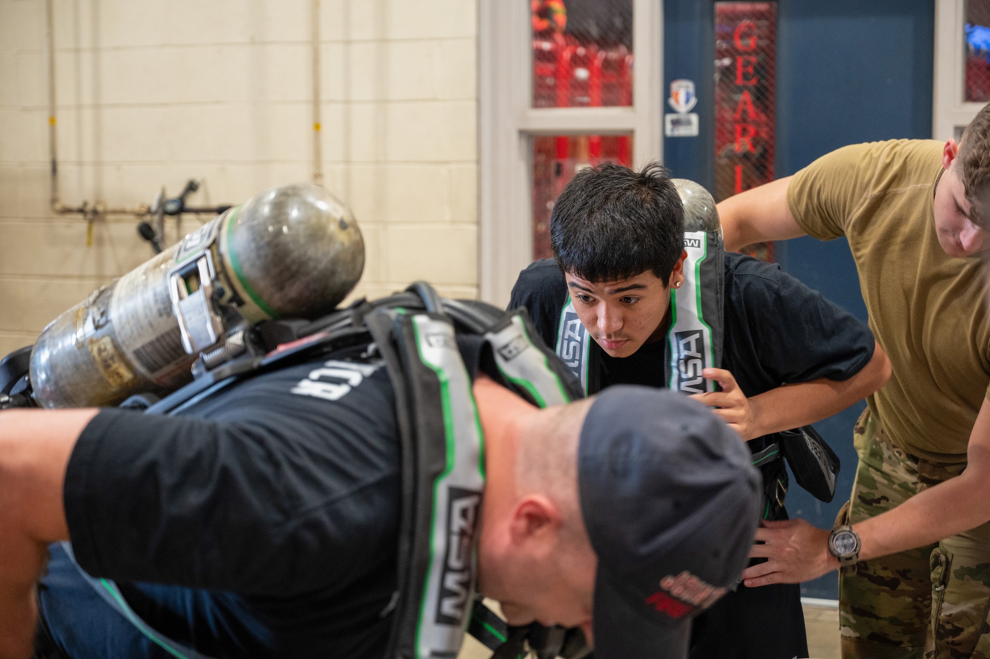 A junior fire academy recruit puts on a self-contained breathing apparatus at Joint Base McGuire-Dix-Lakehurst, N.J., July 28, 2026.