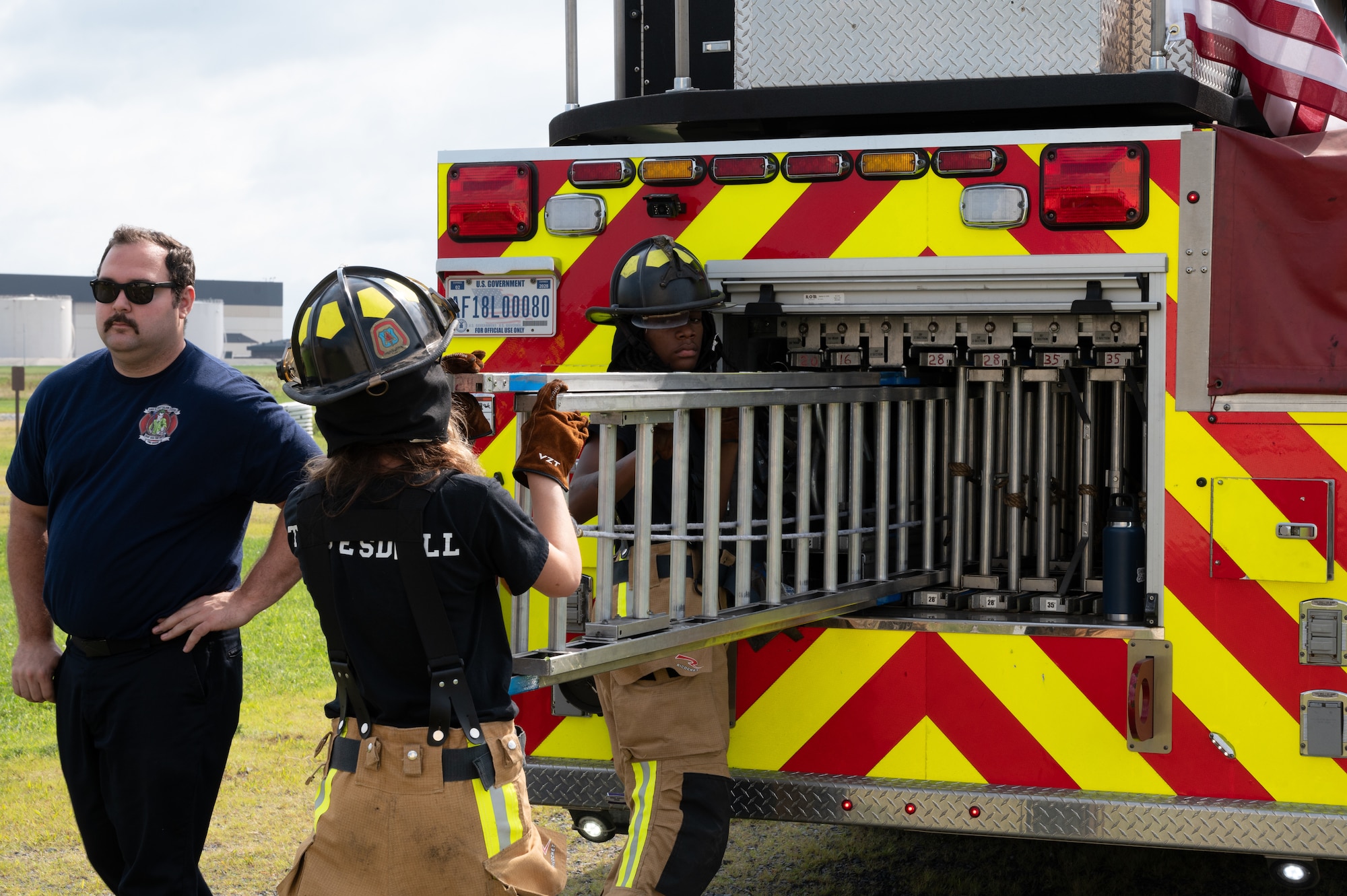 Junior fire academy recruits load a ladder onto a fire engine at Joint Base McGuire-Dix-Lakehurst, N.J., July 29, 2026.
