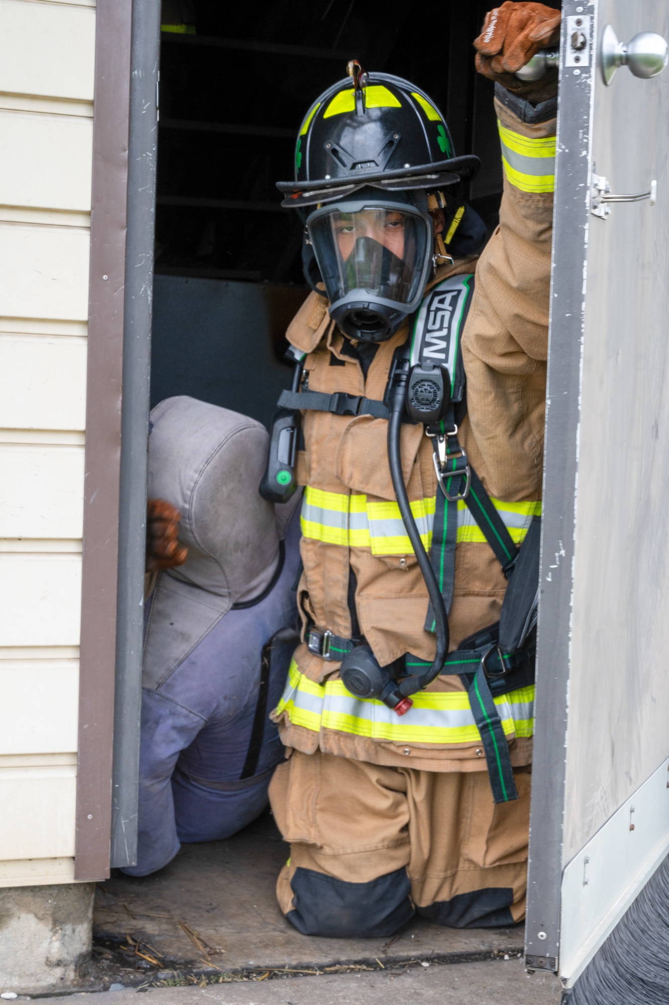 A junior fire academy recruit drags a training dummy out of a building at Joint Base McGuire-Dix-Lakehurst, N.J., July 29, 2026.