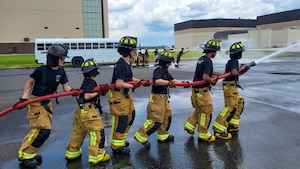 Junior fire academy recruits use a fire hose at Joint Base McGuire-Dix-Lakehurst, N.J., July 29, 2026.
