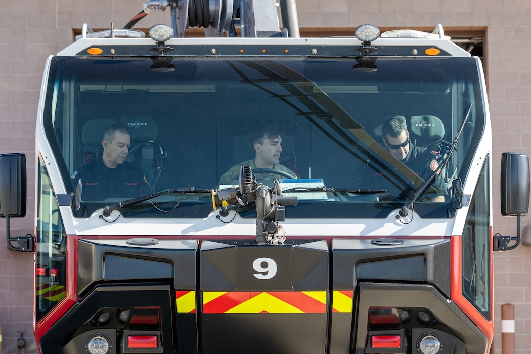 First responders sit inside a rescue vehicle.