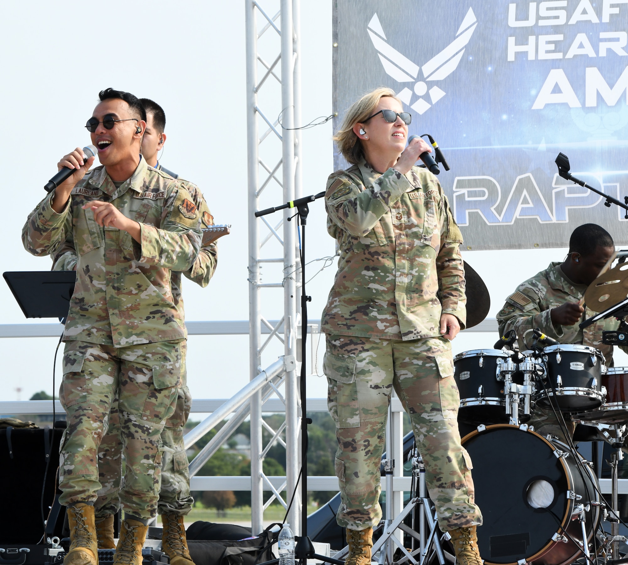 Airman 1st Class Lawrence Laureano and Master Sgt. Rachel Wilson, United States Heartland of America Band vocalists, performs as the opening act during the Defenders of Freedom Air & Space Air Show 2026 at Offutt Air Force Base, Nebraska, Aug. 8, 2026. The event served as a platform to celebrate Offutt's military heritage, honoring the civilian-military bond with the Greater-Omaha community that has supported the nation's defense for generations. (U.S. Air Force photo by Charles J. Haymond)