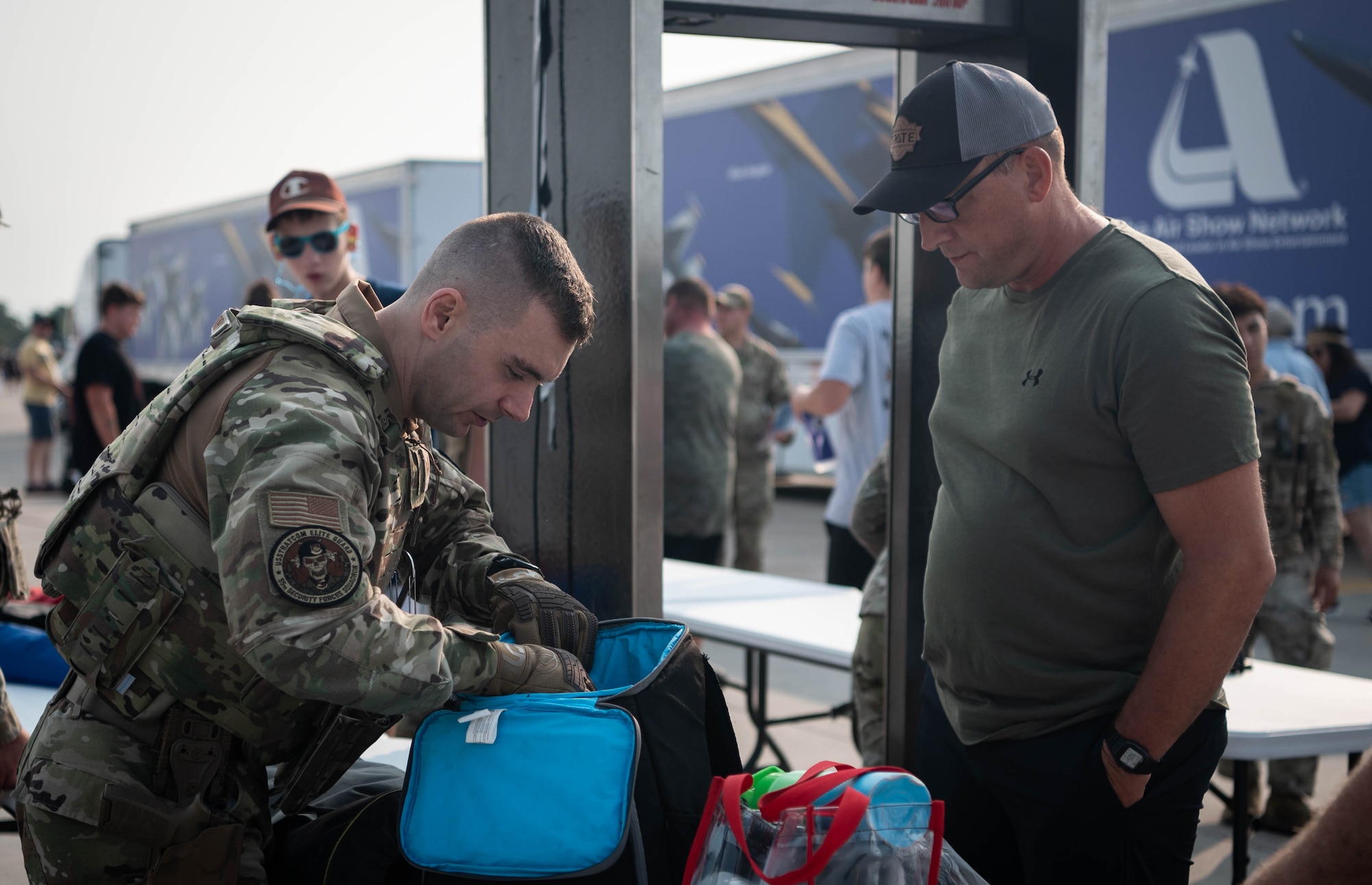 An Airman assigned to the 55th Security Forces Squadron looks through a local patron's bag before gaining entrance to attend the 2026 Defenders of Freedom Air & Space Show at Offutt Air Force Base, Nebraska, Aug. 8, 2026. Defenders of Freedom Air & Space Show 2026 was designed to educate the public on the
strategic importance of Offutt AFB and the many worldwide missions it supports, providing a firsthand look at the advanced aircraft and highly trained personnel required to execute operations globally. (U.S. Air Force photo by Daniel Martinez)