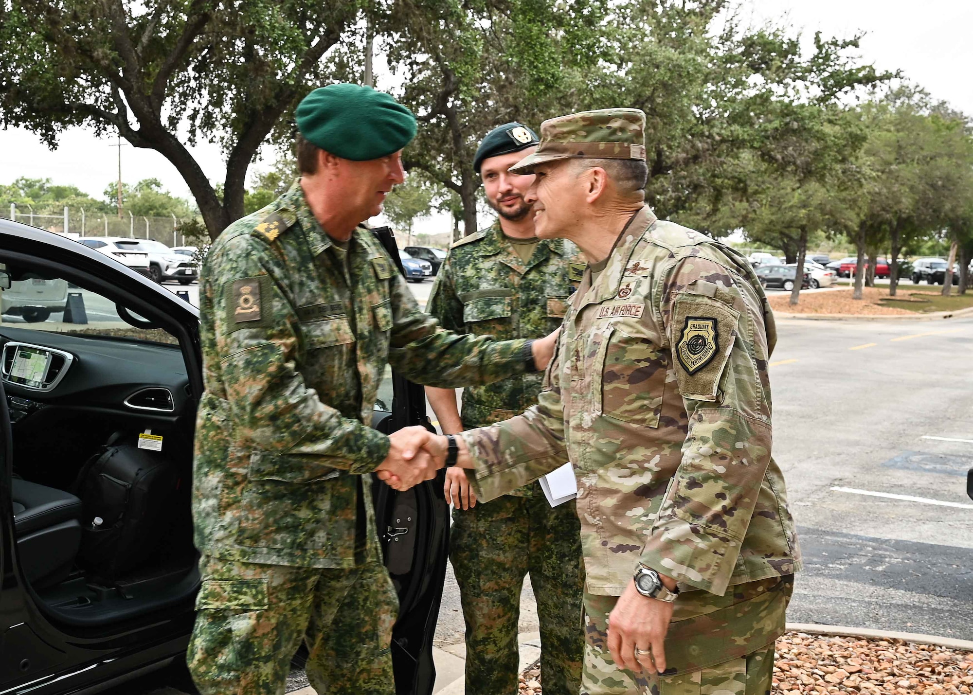 U.S. Air Force Lt. Gen. Thomas Hensley, commander, 16th Air Force (Air Forces Cyber), and Maj. Gen. Van Den Berg, commander of the Netherlands Defence Cyber Command shake hands in greeting.