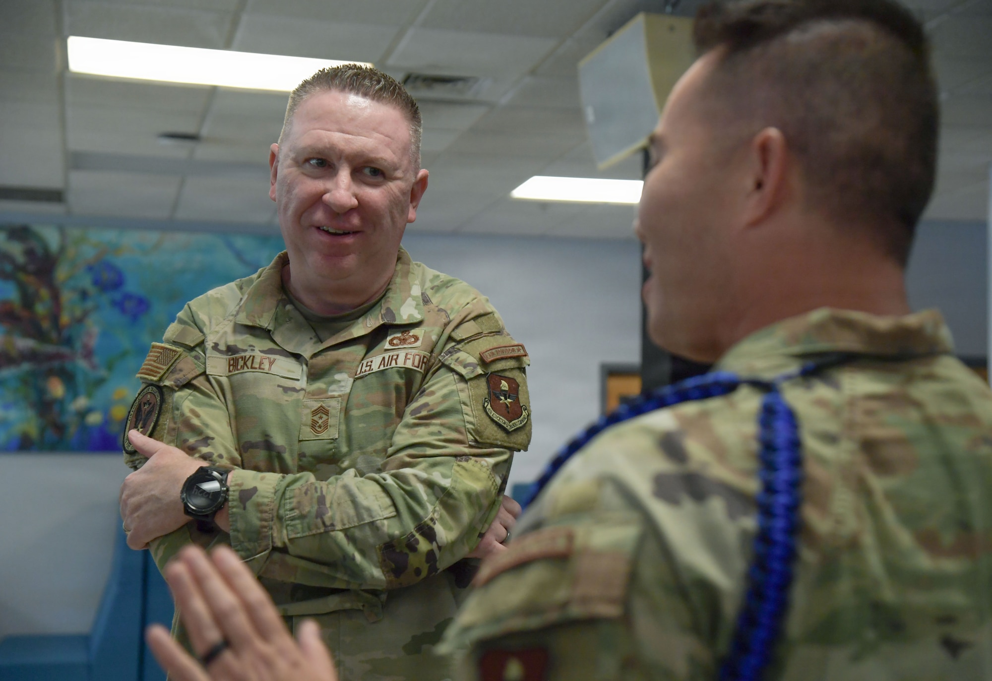 A man in a U.S. Air Force uniform speaks to an Airman.
