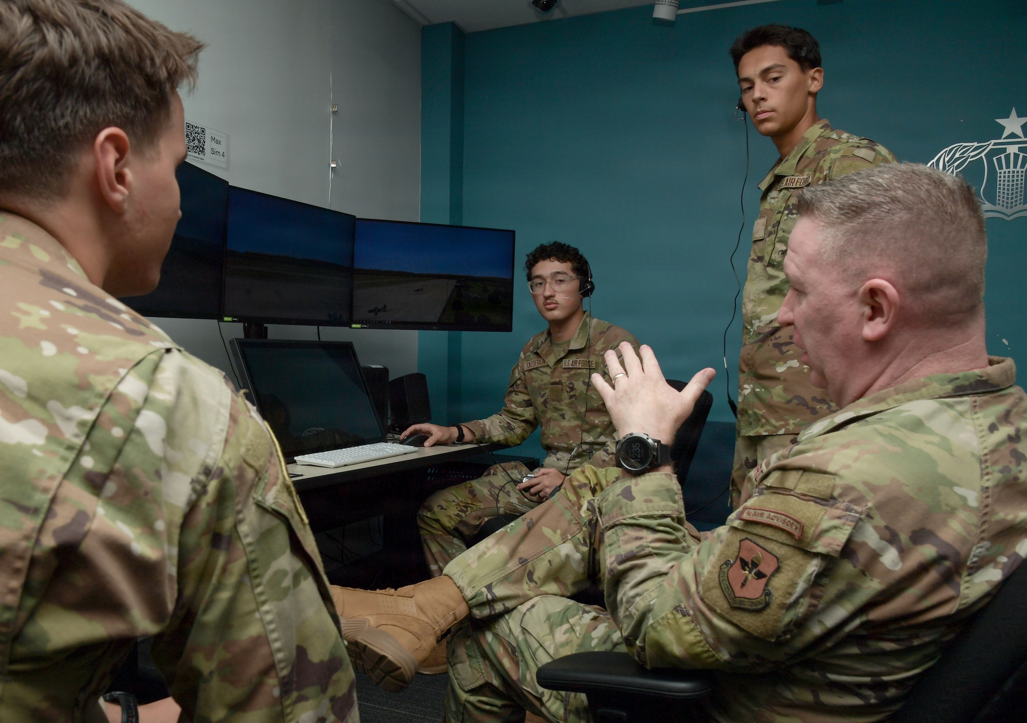 A man in a U.S. Air Force uniform speaks to a group of Airmen.