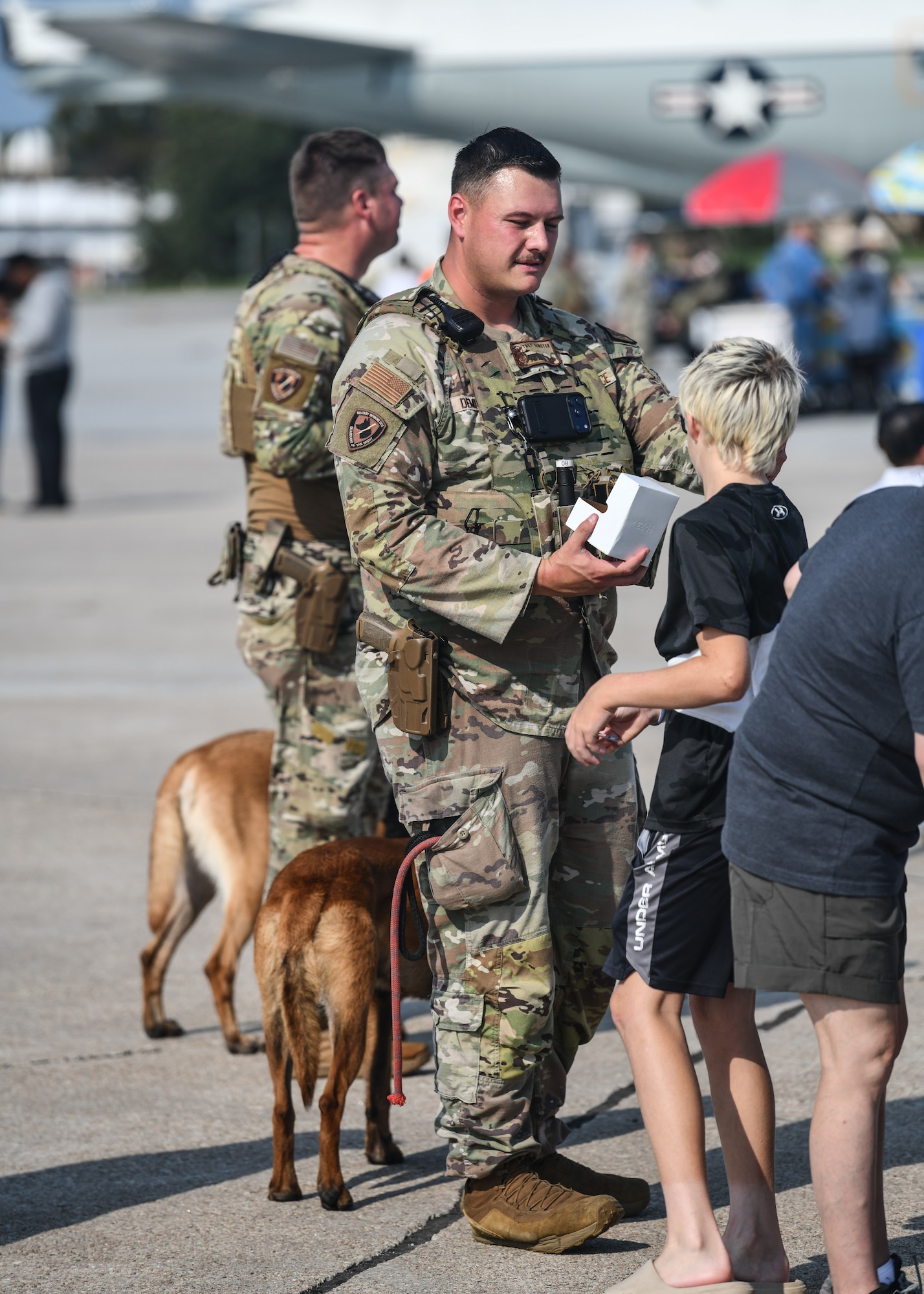Staff Sgt. Trey Demeyer, 55th Security Forces Squadron K-9 handler, interacts with patrons at the Defenders of Freedom Air and Space Show 2026 on Offutt Air Force Base, Aug. 9, 2026. Defenders of Freedom Air & Space Show 2026 served as a free, public open house to foster strong community relations and express appreciation to the local Greater Omaha community. (U.S. Air Force photo by Chad Watkins)