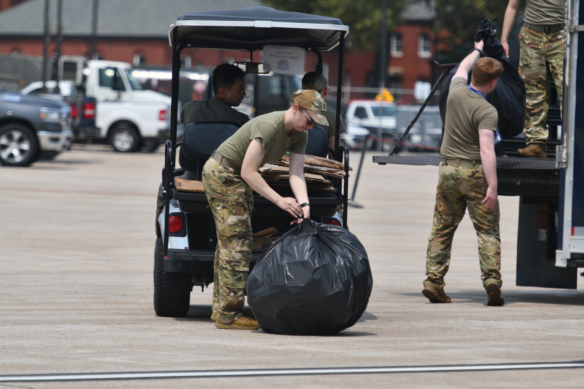 A group of Team Offutt volunteers pick up the trash during the Defenders of Freedom Air & Space Show 2026 at Offutt Air Force Base, Nebraska, Aug. 9, 2026. The air show served as a free, public open house to foster strong community relations and express appreciation to the local Greater-Omaha community. (U.S. Air Force photo by Chad Watkins)
