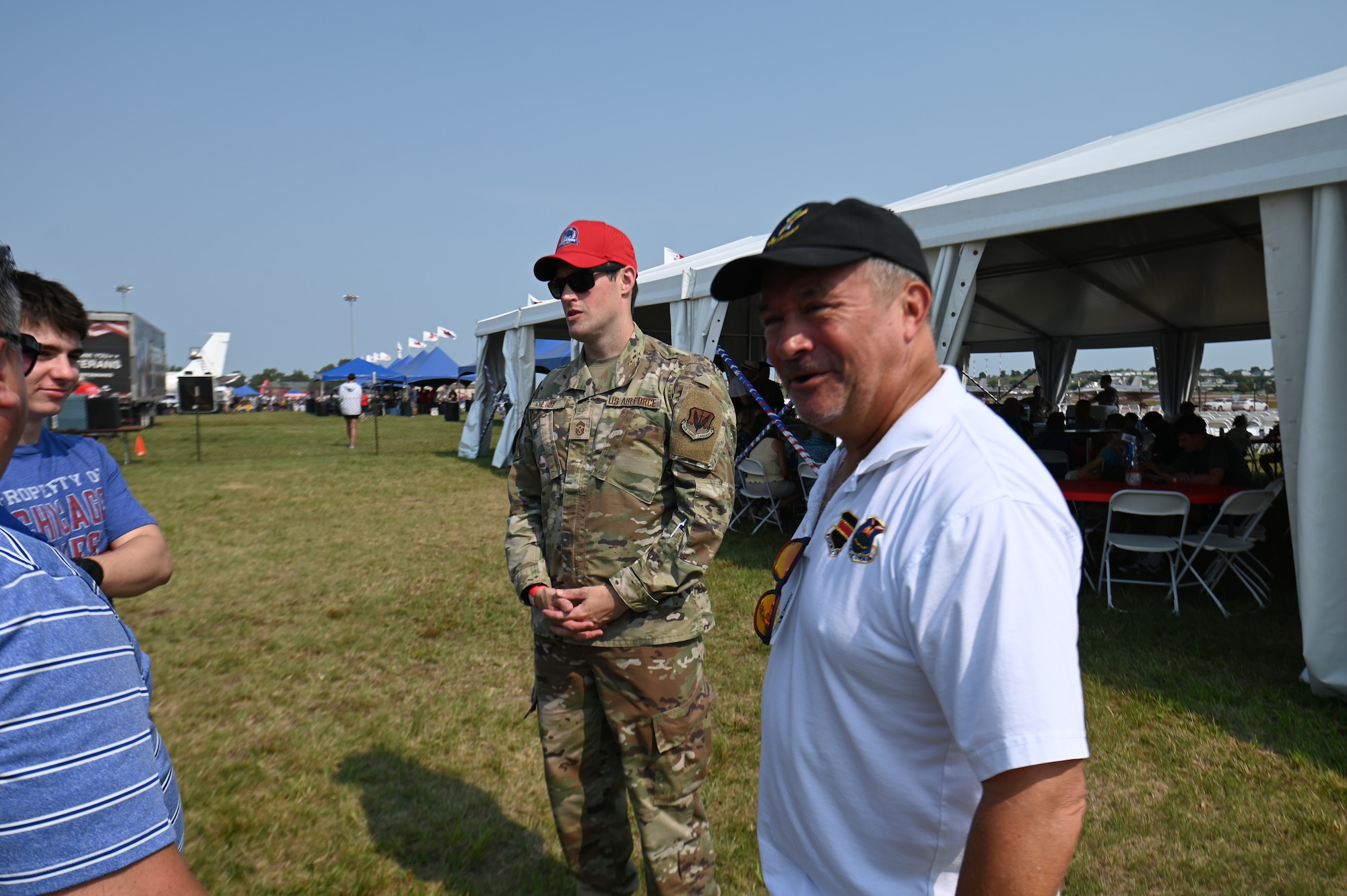 Chief Master Sgt. Alex Eudy (left), 55th wing command chief, and Congressman Don Bacon (right), Nebraska District 2, talk to spectators at Defenders of Freedom Air & Space Show 2026 at Offutt Air Force Base, Nebraska, Aug. 9, 2026. The air show is an opportunity to have military leaders and community leaders interact with the community to build relationships. (U.S. Air Force photo by Airman 1st Class Charles Bolden)