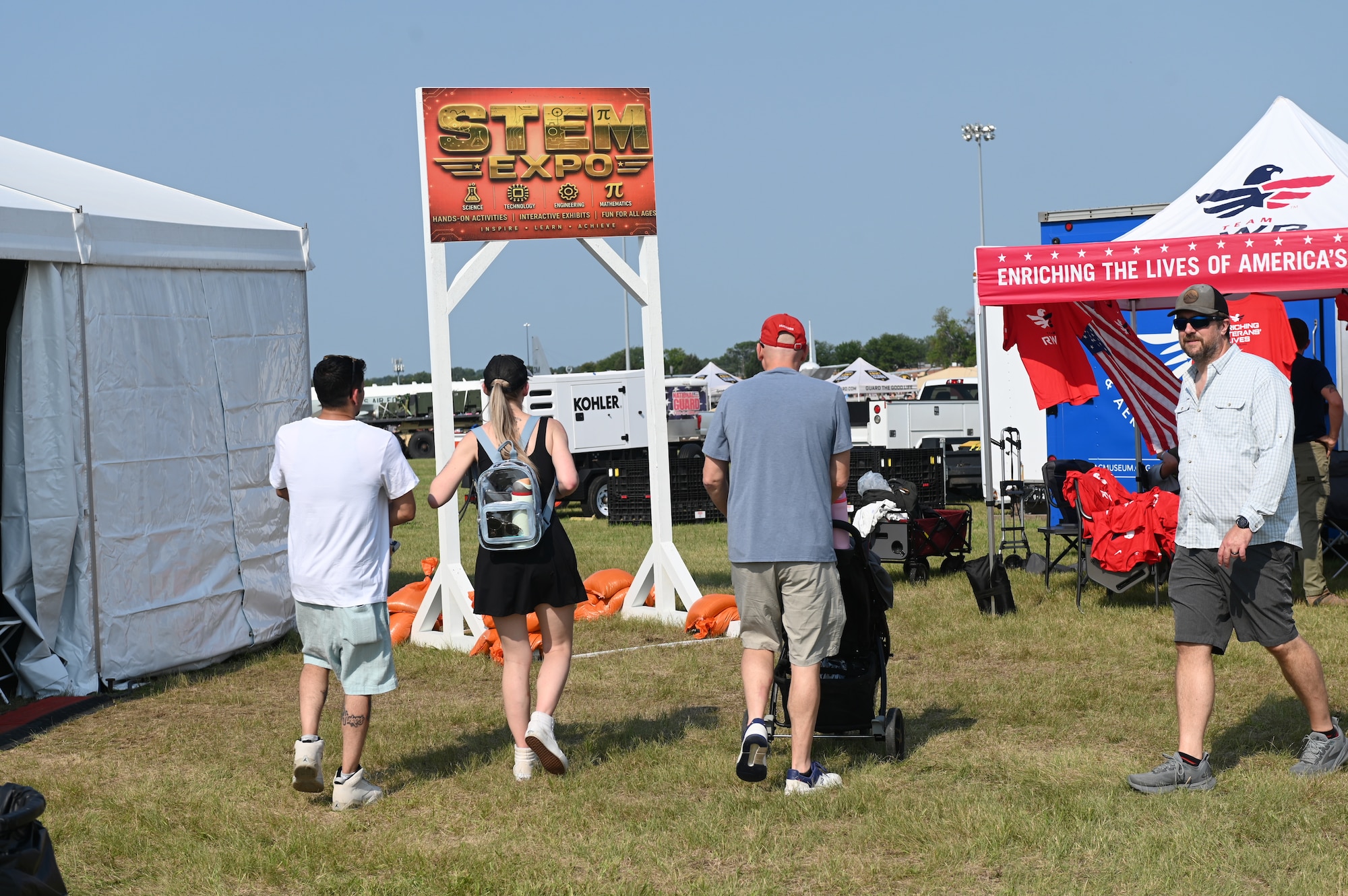 Defenders of Freedom Air & Space Show 2026 spectators walk by the STEM tent entrance on Offutt Air Force Base, Nebraska, Aug. 9, 2026. The tent was set up at the air show to educate spectators about various projects improving STEM fields.(U.S. Air Force photo by Airman 1st Class Charles Bolden)