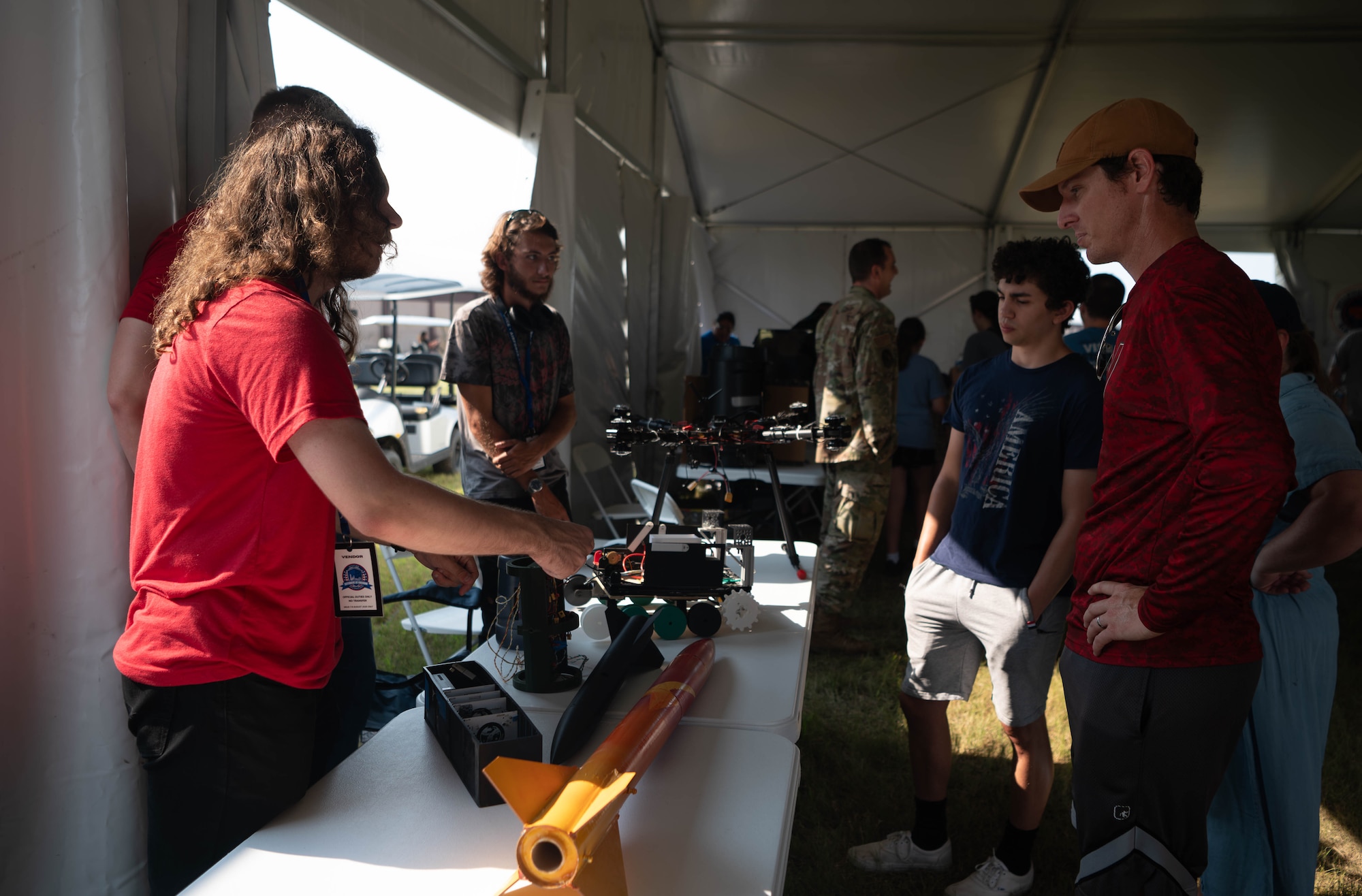 A volunteer discusses general rocket mechanics to attendees exploring the STEM tent during the 2026 Defenders of Freedom Air & Space Show at Offutt Air Force Base, Nebraska, Aug. 9, 2026. The open house provided a rare opportunity for local Greater Omaha residents to interact directly with service members, ask questions, and explore the military aircraft that make the nation's global defense possible.(U.S. Air Force photo by Daniel Martinez)
