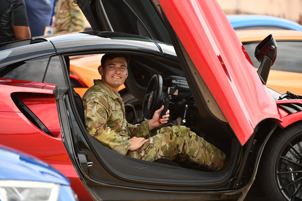Airman 1st Class Charles Bolden, 55th Wing public affairs specialist, sits in a McLaren Actura before participating in a race during the Defenders of Freedom Air and Space Show at Offutt Air Force Base, Nebraska, Aug. 7, 2026. Defenders of Freedom Air & Space Show 2026 served as a free, public open house to foster strong community relations and express appreciation to the local Greater Omaha community. (U.S. Air Force photo by Chad Watkins)