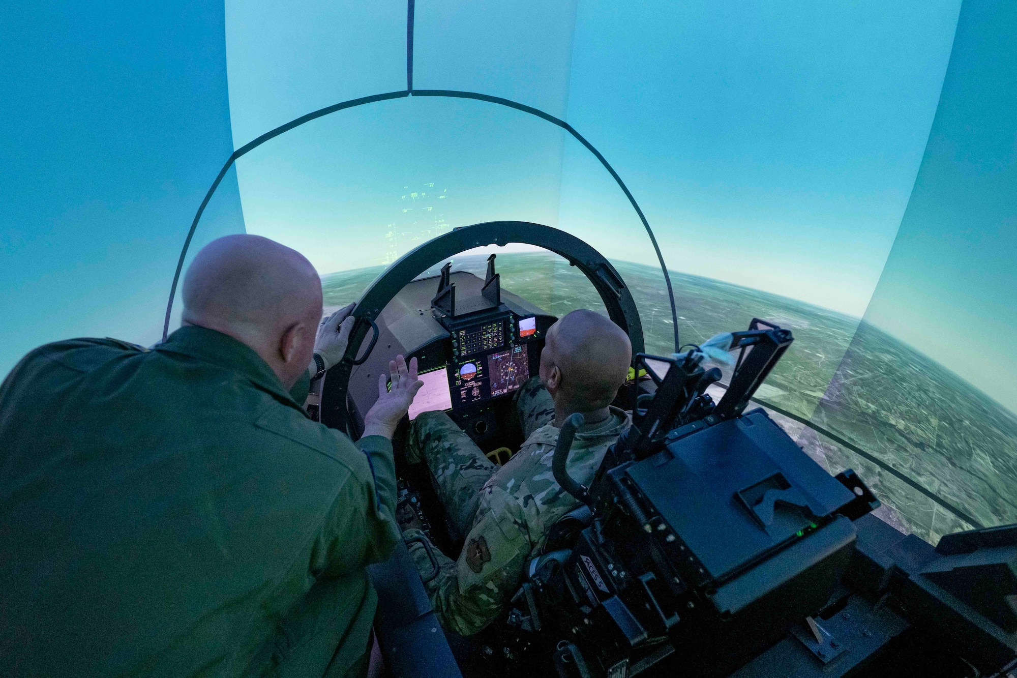 U.S. Air Force Maj. Gen. Roy Collins, Air Education and Training Command deputy commander, pilots a T-7A Red Hawk in the Ground Base Training System during his tour of the 12th Training Squadrons T-7A simulators at Joint Base San Antonio-Randolph, July 29, 2026. The visit allowed Collins to gain firsthand insight into how the T-7A Red Hawk GBTS will be used to prepare future Air Force pilots. During the tour, he learned how the integrated simulator and aircraft training environment will enhance undergraduate pilot training by providing students with realistic, high-fidelity instruction before they transition to flying the aircraft.