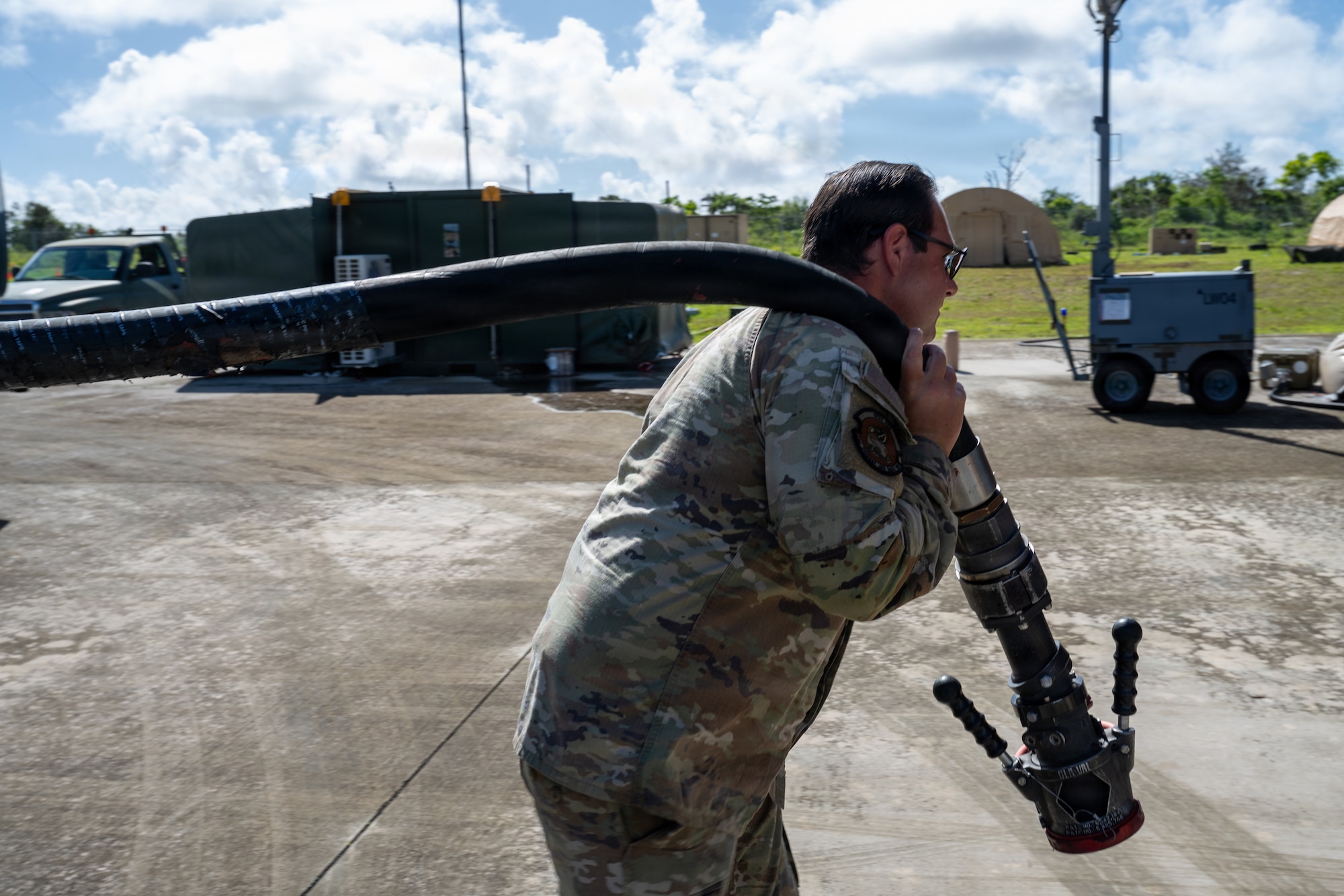 U.S. Air Force Tech. Sgt. Luke Gaines, 21st Combat Air Base Squadron fuels distribution NCO in charge, drags a fuel hose during Exercise Valiant Shield 2026 on Rota, Commonwealth of the Northern Mariana Islands, June 29, 2026. VS26 prepares the joint and combined force to rapidly respond to crises and contingencies across the spectrum of operations from humanitarian assistance and disaster response to armed conflict. (U.S. Air Force photo by Senior Airman Adrien Tran)