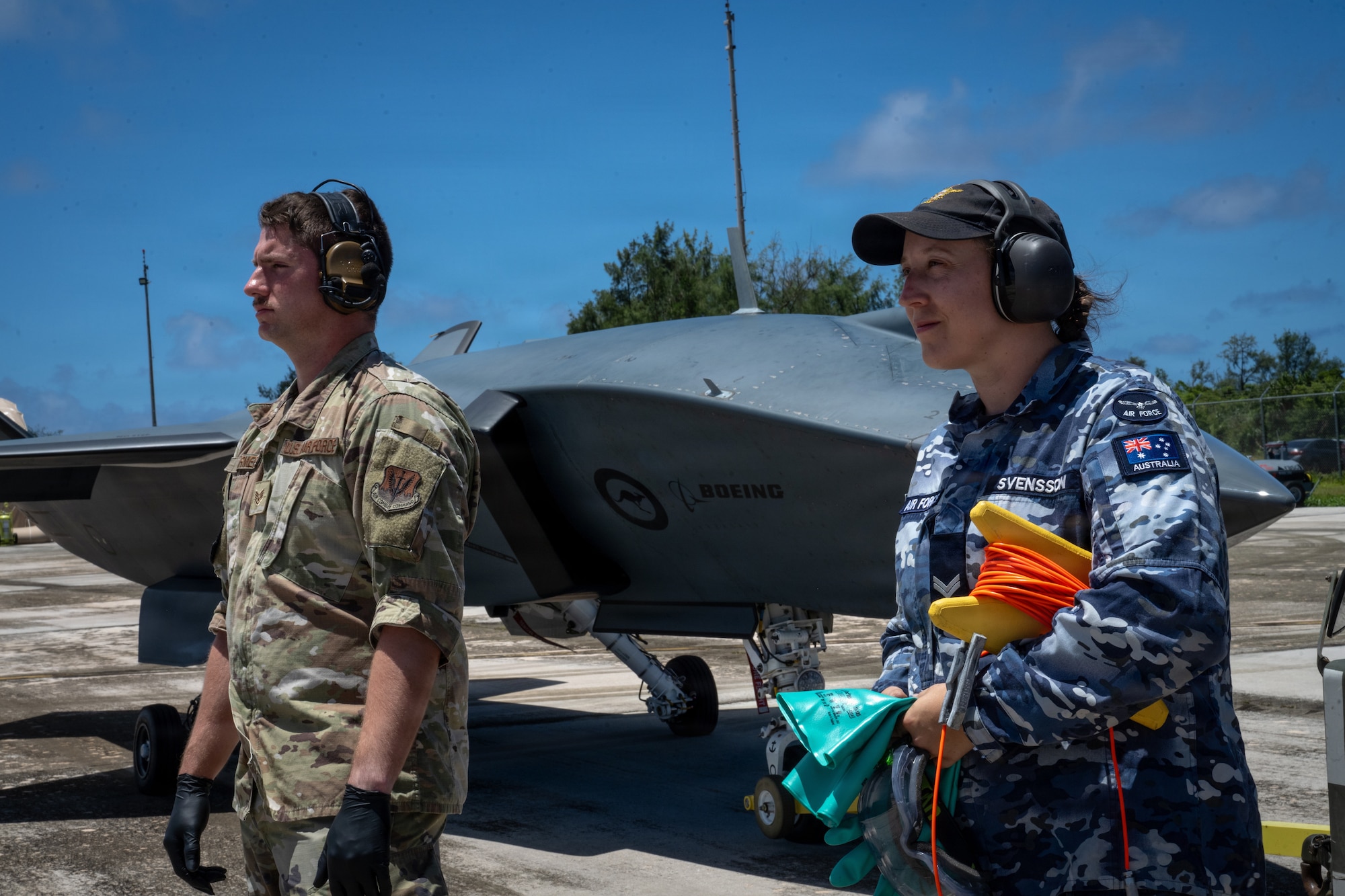 U.S. Air Force Staff Sgt. Chayze Farmer, Experimental Operations Unit collaborative combat aircraft maintenance tactics developer, left, and Royal Australian Air Force Corporal Ceillagh Svensson, Aircraft Research and Development Unit aircraft technician, right, prepare to conduct a simulated forward area refueling point exercise during Exercise Valiant Shield 2026 on Rota, Commonwealth of the Northern Mariana Islands, June 28, 2026. VS26 brings together U.S. joint forces and allies to strengthen interoperability, enhance combined readiness and demonstrate a shared commitment to a free and open Indo-Pacific. (U.S. Air Force photo by Senior Airman Adrien Tran)