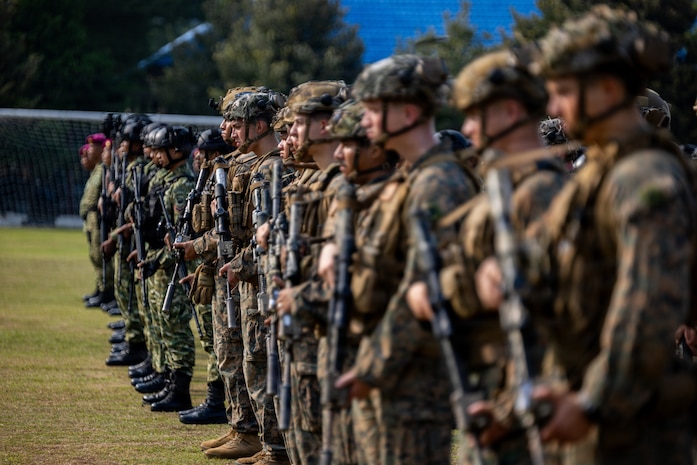 U.S. Marines with Alpha Company, 1st Battalion, 5th Marine Regiment, Marine Rotational Force – Darwin 26, and Indonesian marines with 7th Infantry Battalion, 4th Infantry Brigade, stand at attention during an opening ceremony as part of a platoon exchange at the Indonesian Marine Corps 7th Battalion base near Lampung, Indonesia, Aug. 12, 2026.