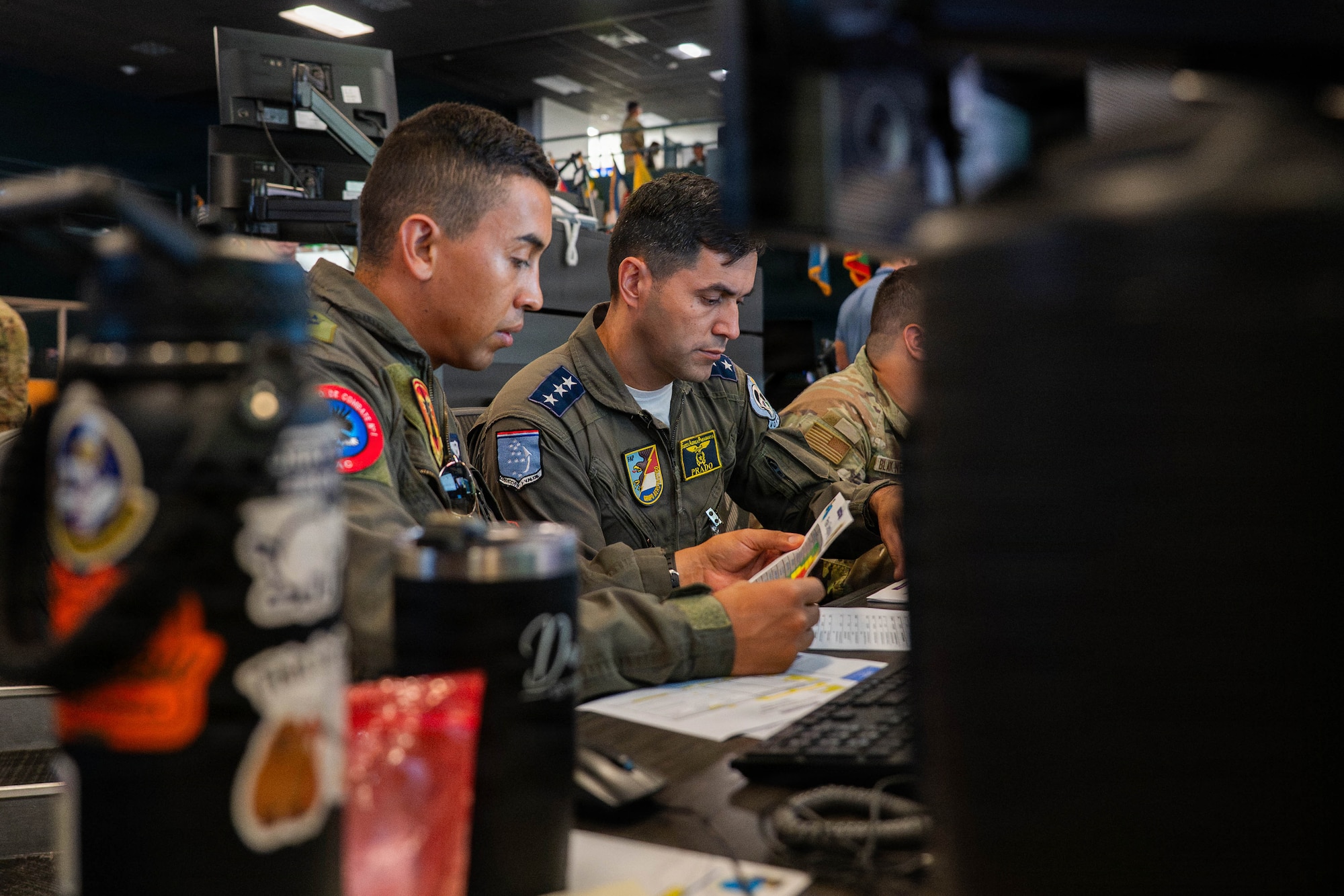 Multinational air force participants discuss air plans and strategies during Exercise PANAMAX 2026 inside the Combined Air Operations Center at Davis-Monthan Air Force Base, Arizona, Aug. 6, 2026.