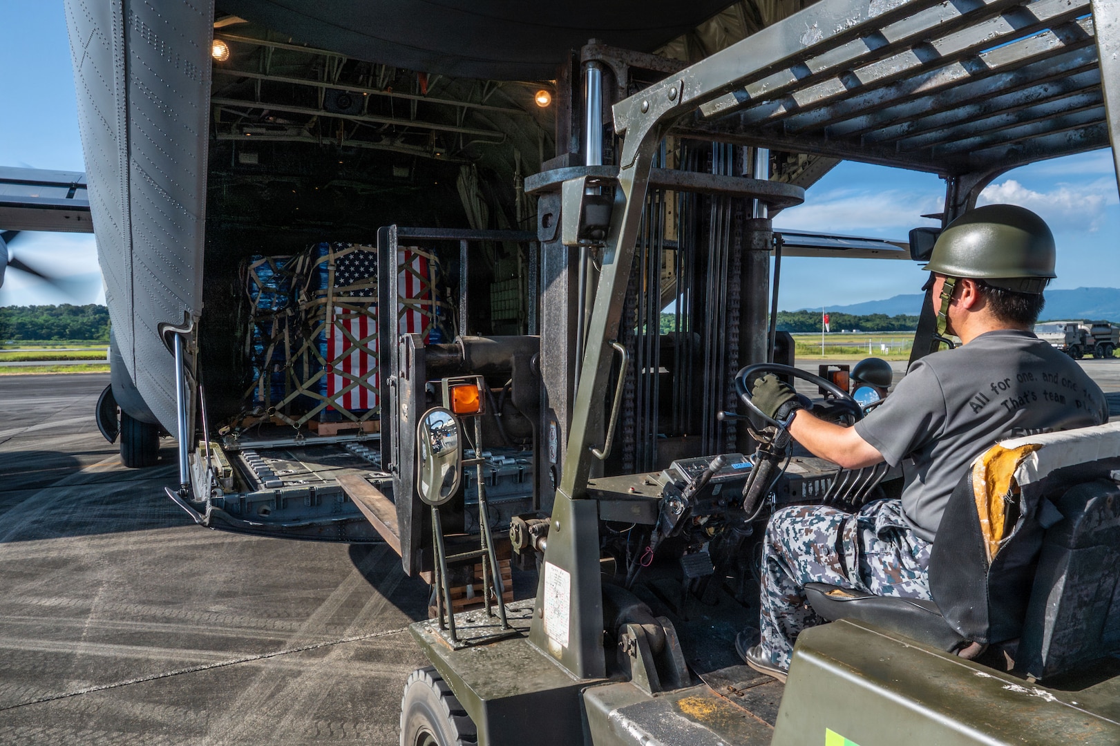 A forklift next to an aircraft