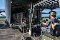 A forklift next to an aircraft