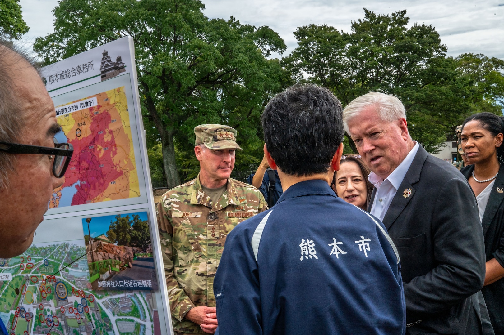 Group of people surrounding a poster board